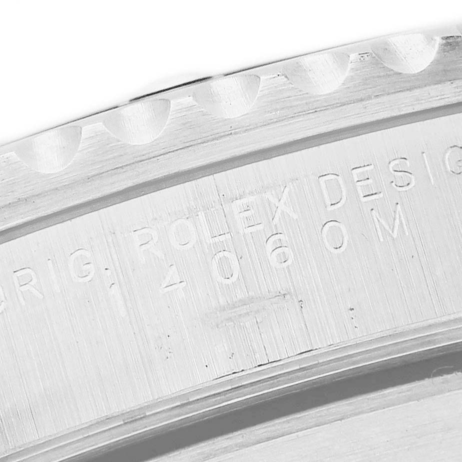 The image shows a close-up of the engraved inner bezel of a Rolex Submariner 14060 Men's Stainless Steel Black Dial watch.