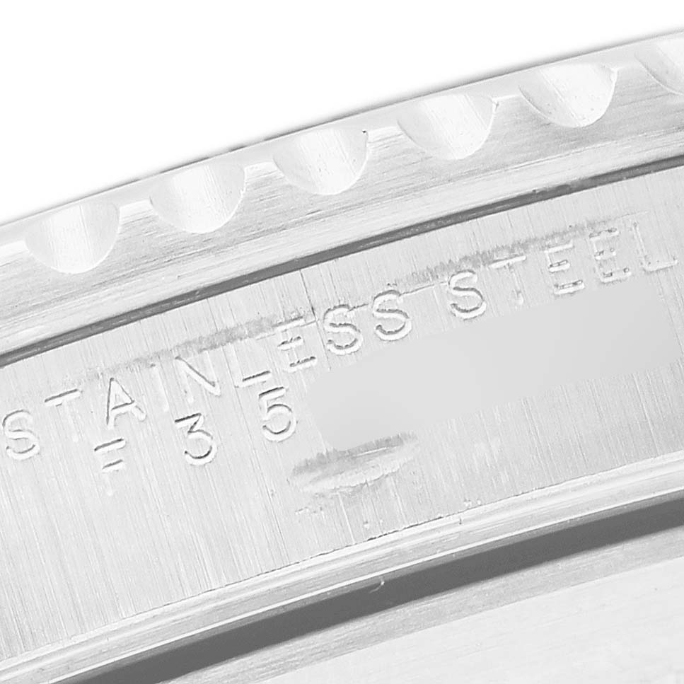 The image shows the engraved stainless steel back edge of a Rolex Submariner 14060 Men's Stainless Steel Black Dial watch.