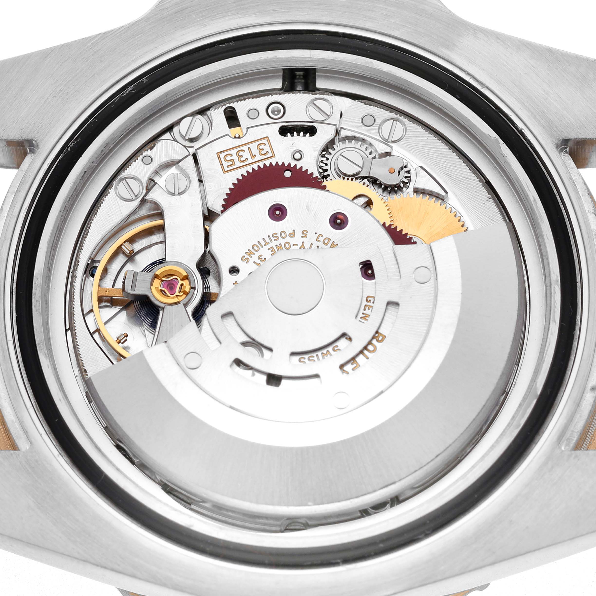 The image shows the internal movement of a Rolex Submariner 116613 Men's Steel and Gold (two tone) Black Dial from the back, highlighting the gears and mechanical parts.