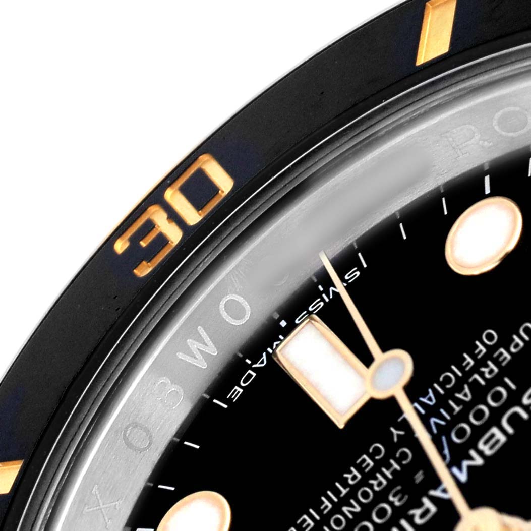 The image shows a close-up of the bezel and part of the dial of the Rolex Submariner 116613 Men's Steel and Gold (two tone) Black Dial, focusing on the 30-minute mark and dial details.