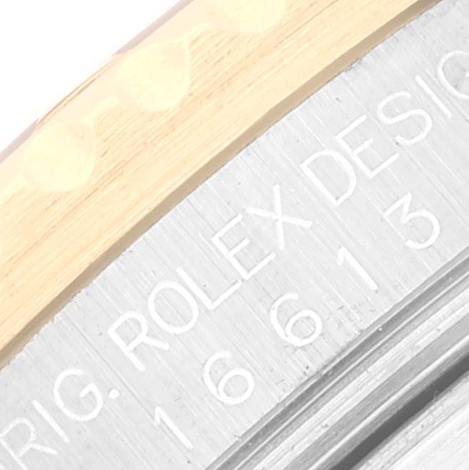 This image shows a close-up of the engraved bezel and design number on a Rolex Submariner 16613 Men's Steel and Gold (two tone) Black Dial 16613 Men's Steel and Gold (two tone) Black Dial watch.