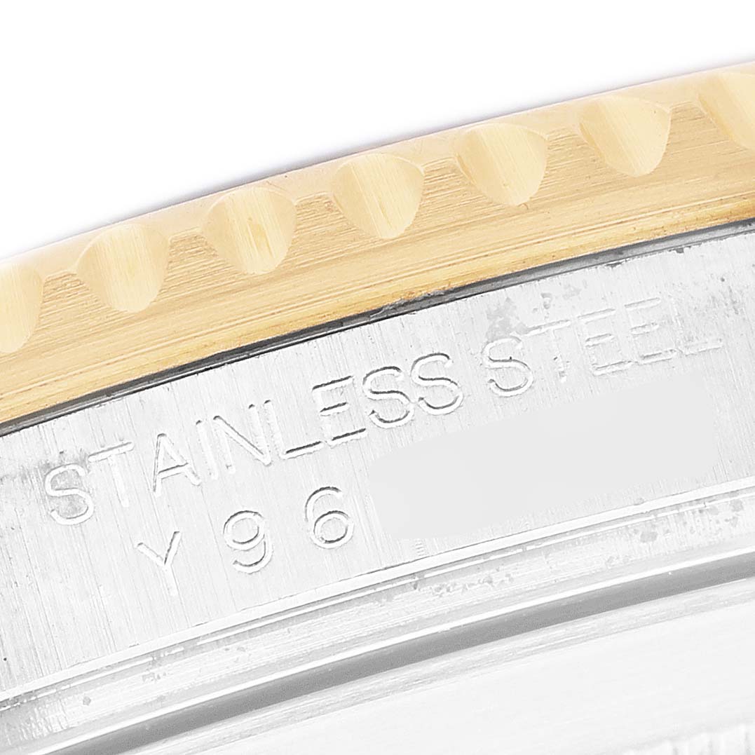 The image shows a close-up of the case back engraving on a Rolex Submariner 16613 Men's Steel and Gold (two tone) Black Dial, highlighting the stainless steel text.