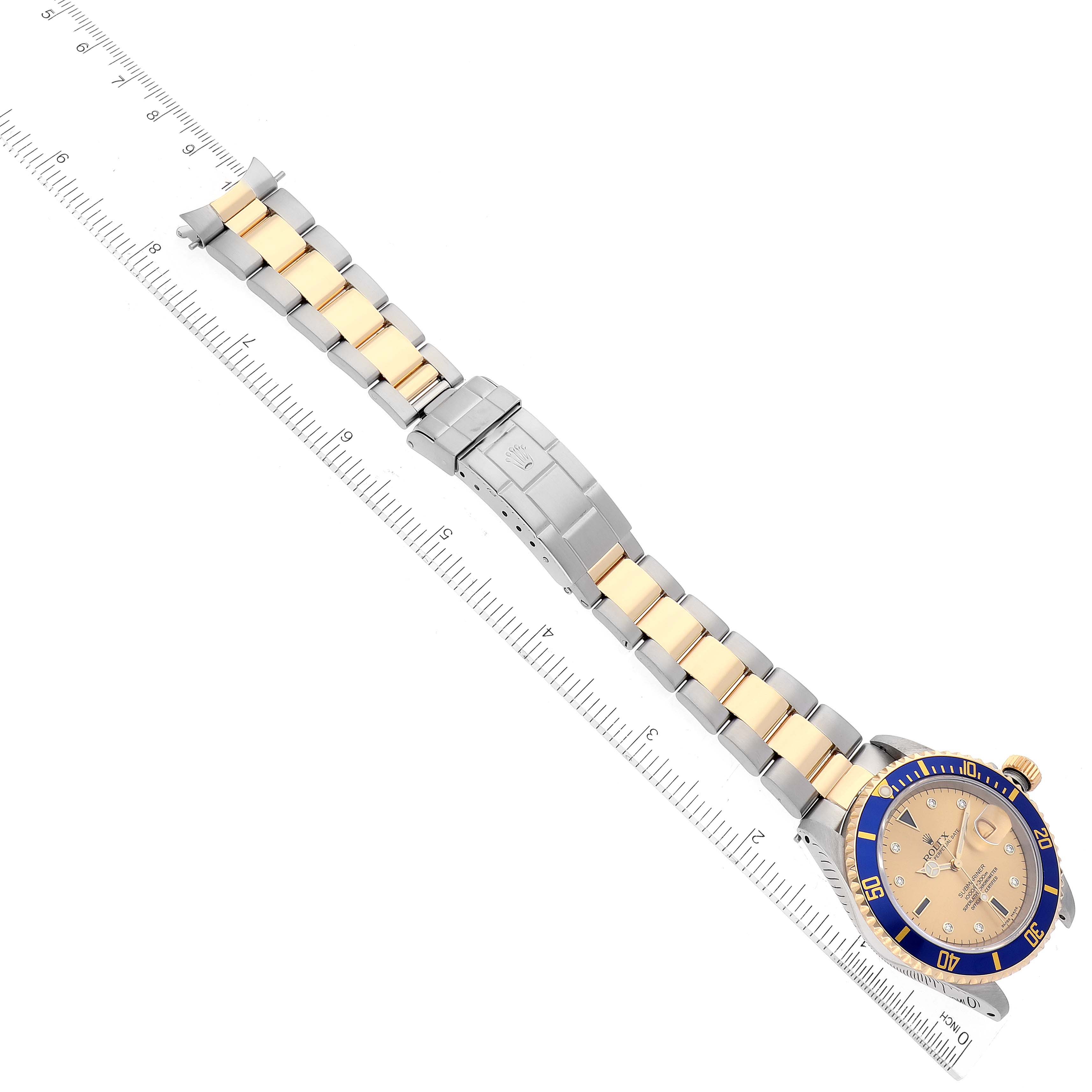 The image shows a top-down view of a Rolex Submariner 16613 Men's Steel and Gold (two tone) Champagne Dial 16613 Men's Steel and Gold (two tone) Champagne Dial watch, highlighting its band, clasp, and part of the bezel and dial.