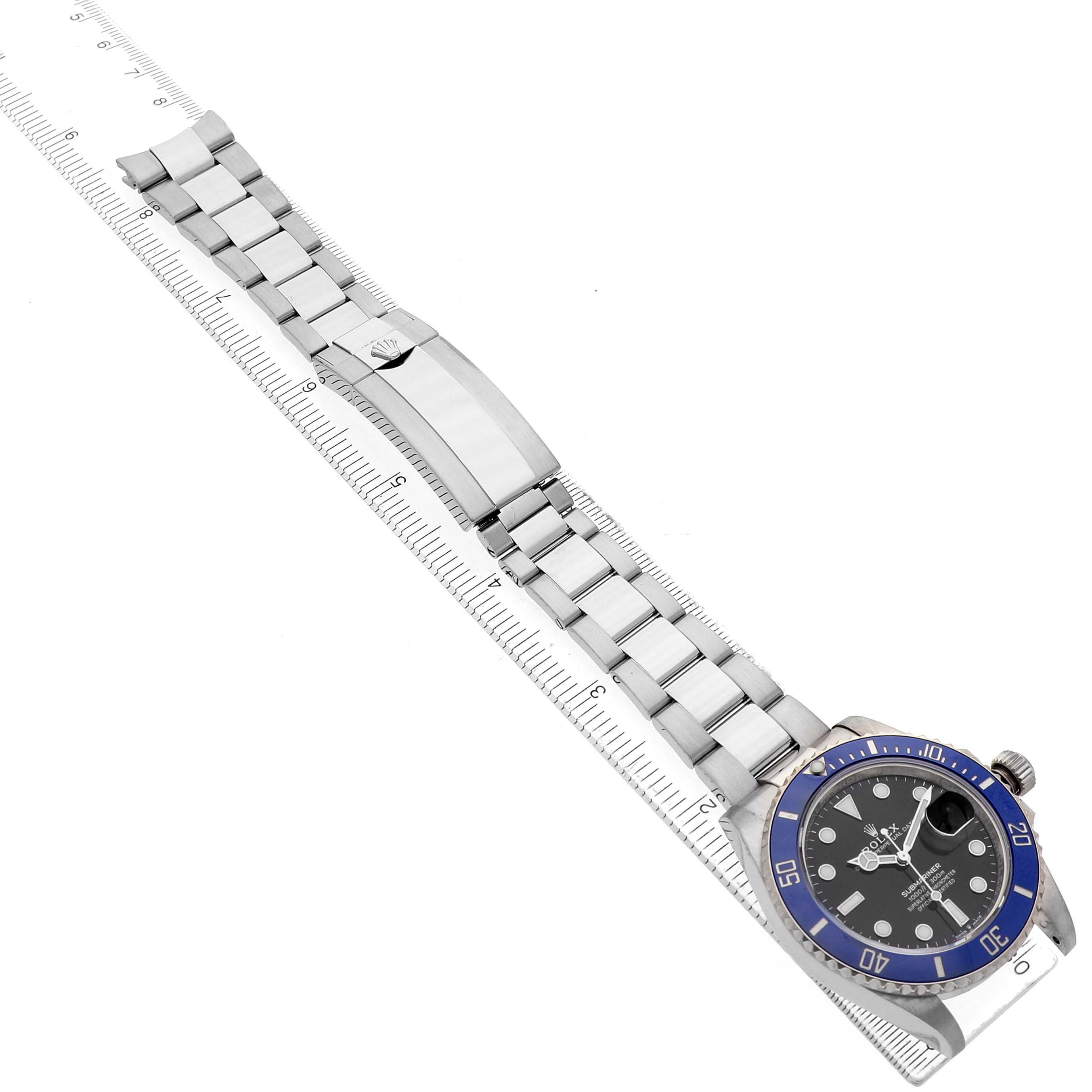 The Rolex Submariner 126619 Men's White Gold Black Dial watch is shown at an angled side view, displaying the bracelet, clasp, and bezel.
