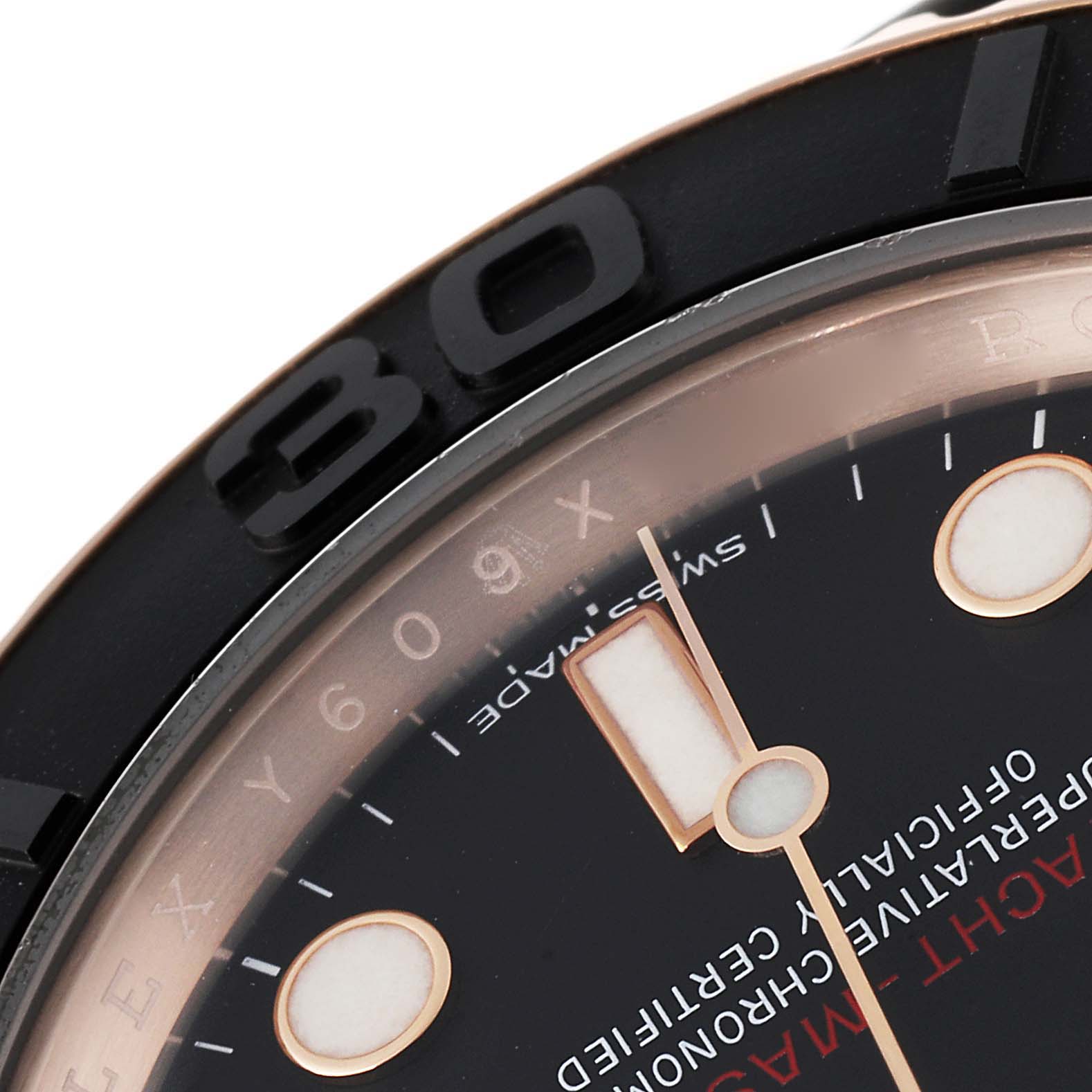 This close-up image of the Rolex Yacht-Master 116655 Men
s Rose Gold Black Dial 116655 Men
s Rose Gold Black Dial watch shows part of the bezel, dial, and hour markers.