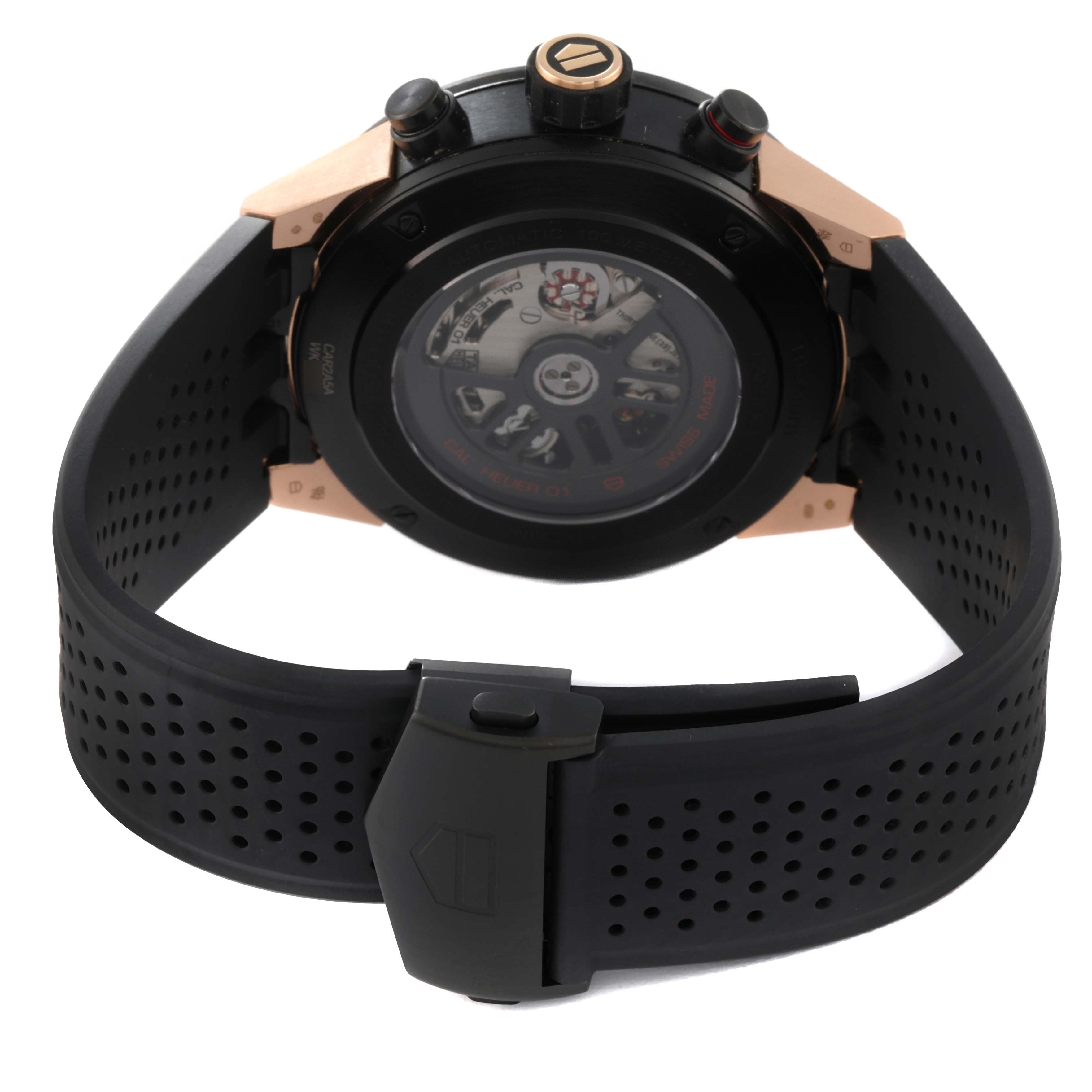 The image shows the back view of the Carrera model by Tag Heuer, featuring its movement and perforated rubber strap.