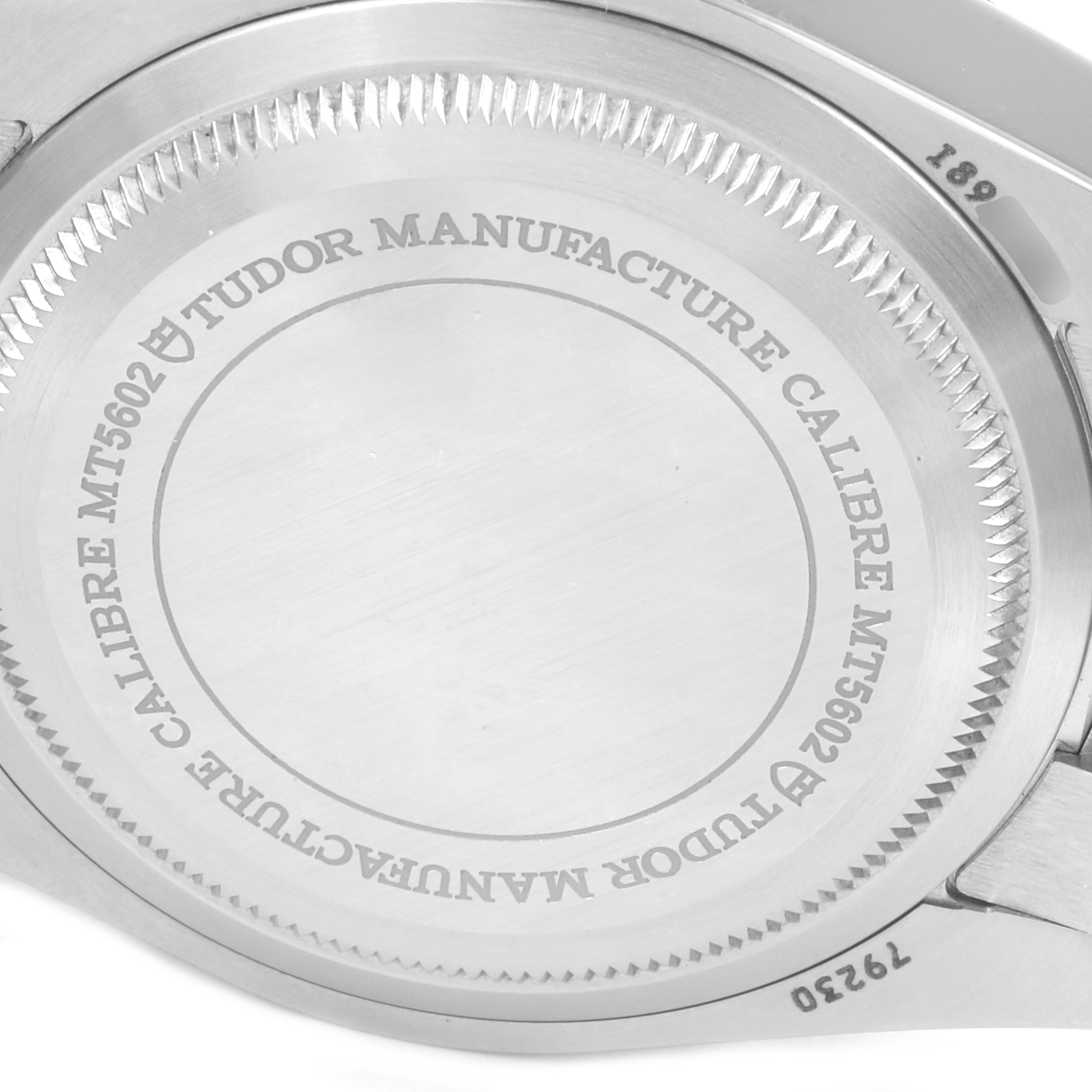 This image shows the case back of a Tudor Heritage Black Bay 79230R Men
s Stainless Steel Black Dial 79230R Men
s Stainless Steel Black Dial watch, highlighting the engraved text and serial number.