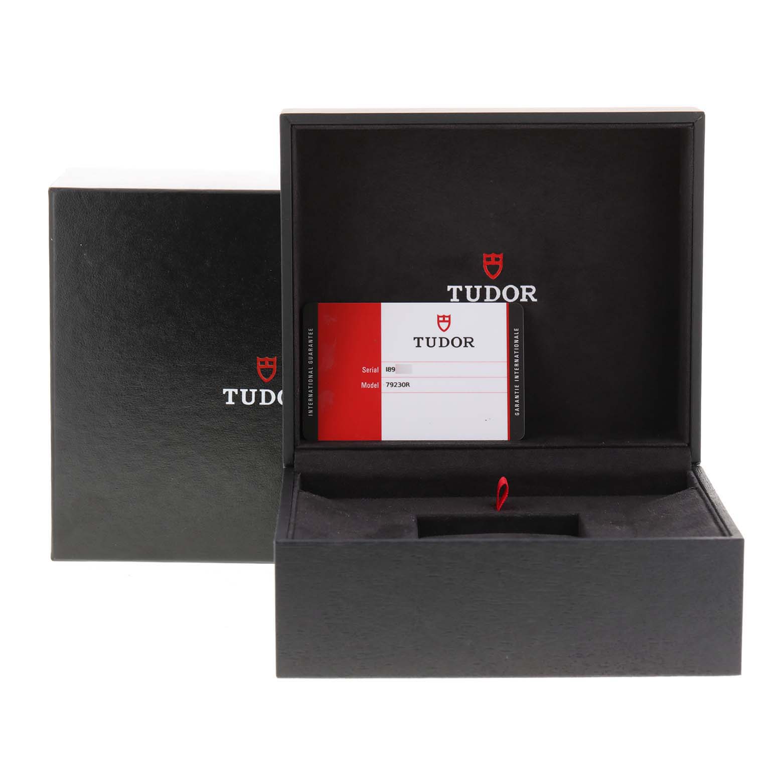 The image shows a Tudor Heritage Black Bay 79230R Men
s Stainless Steel Black Dial 79230R Men
s Stainless Steel Black Dial watch box with the model card displayed inside.
