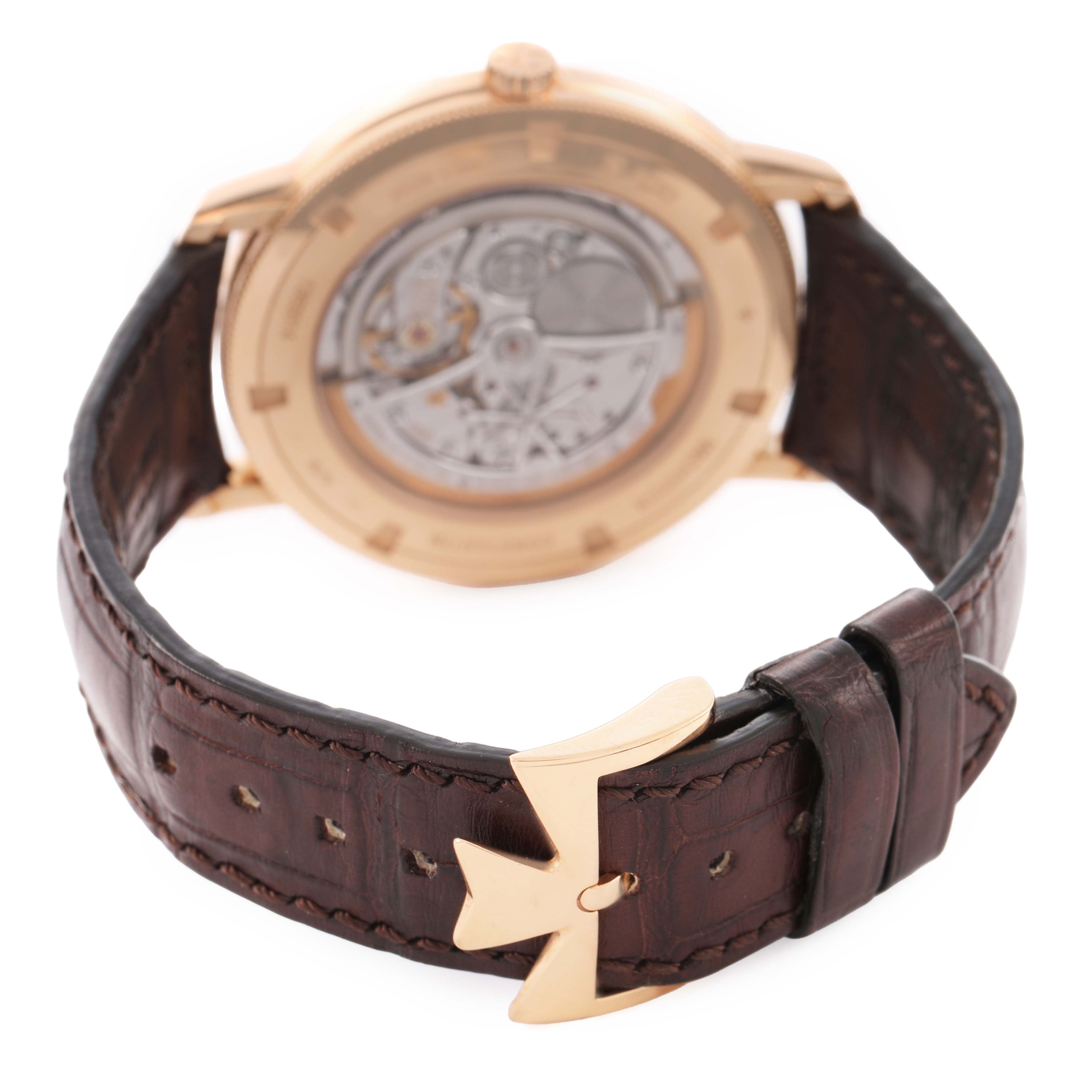 The image shows the back of a Vacheron Constantin Traditionnelle 43075/000R-9737 Men's Rose Gold Silver Dial watch, highlighting the open case back and leather strap with a clasp.