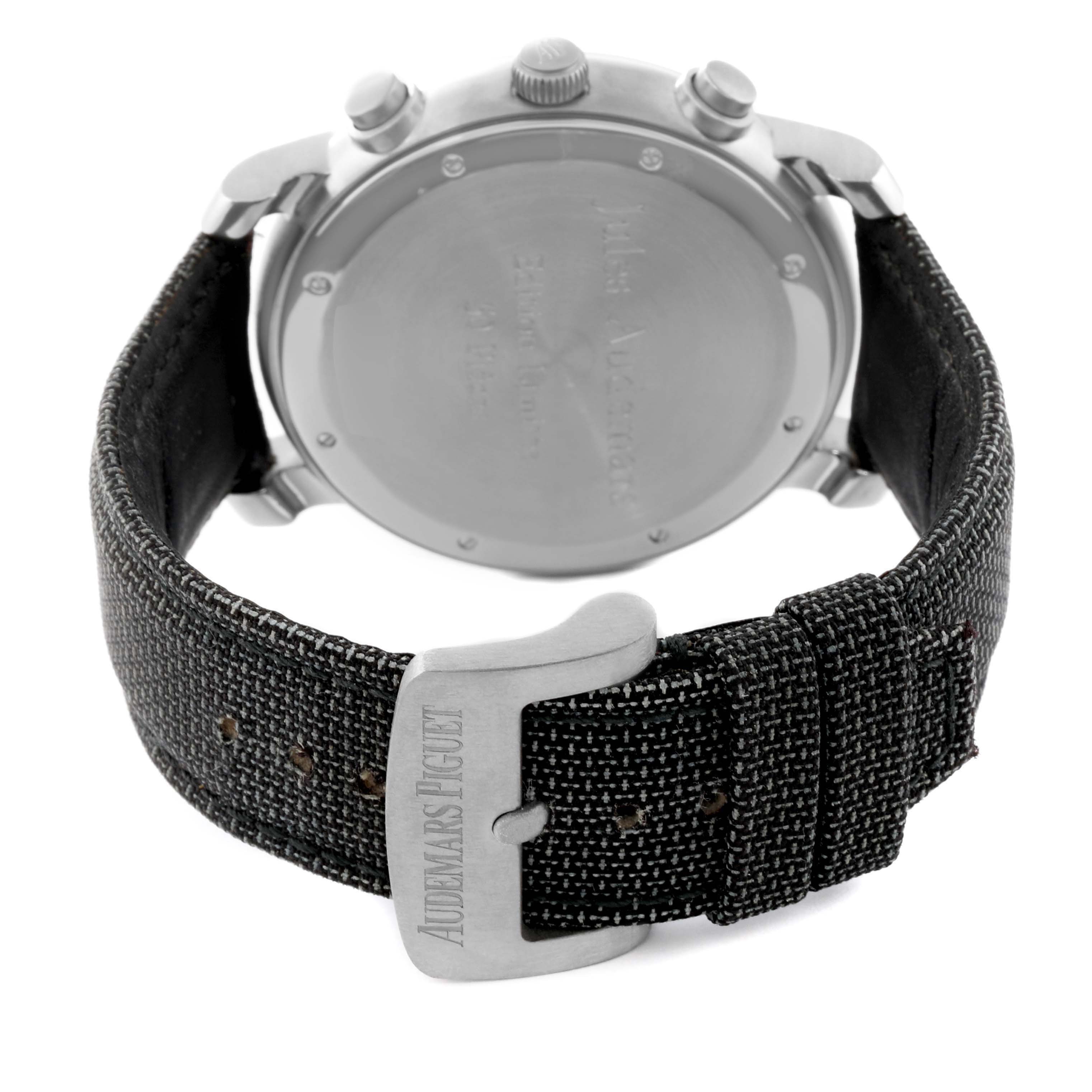 The image shows the back of an Audemars Piguet Jules 25949IP.0.0001KE.01 Men's Titanium Green Dial 25949IP.0.0001KE.01 Men's Titanium Green Dial model watch and its textured black strap with a metal buckle.