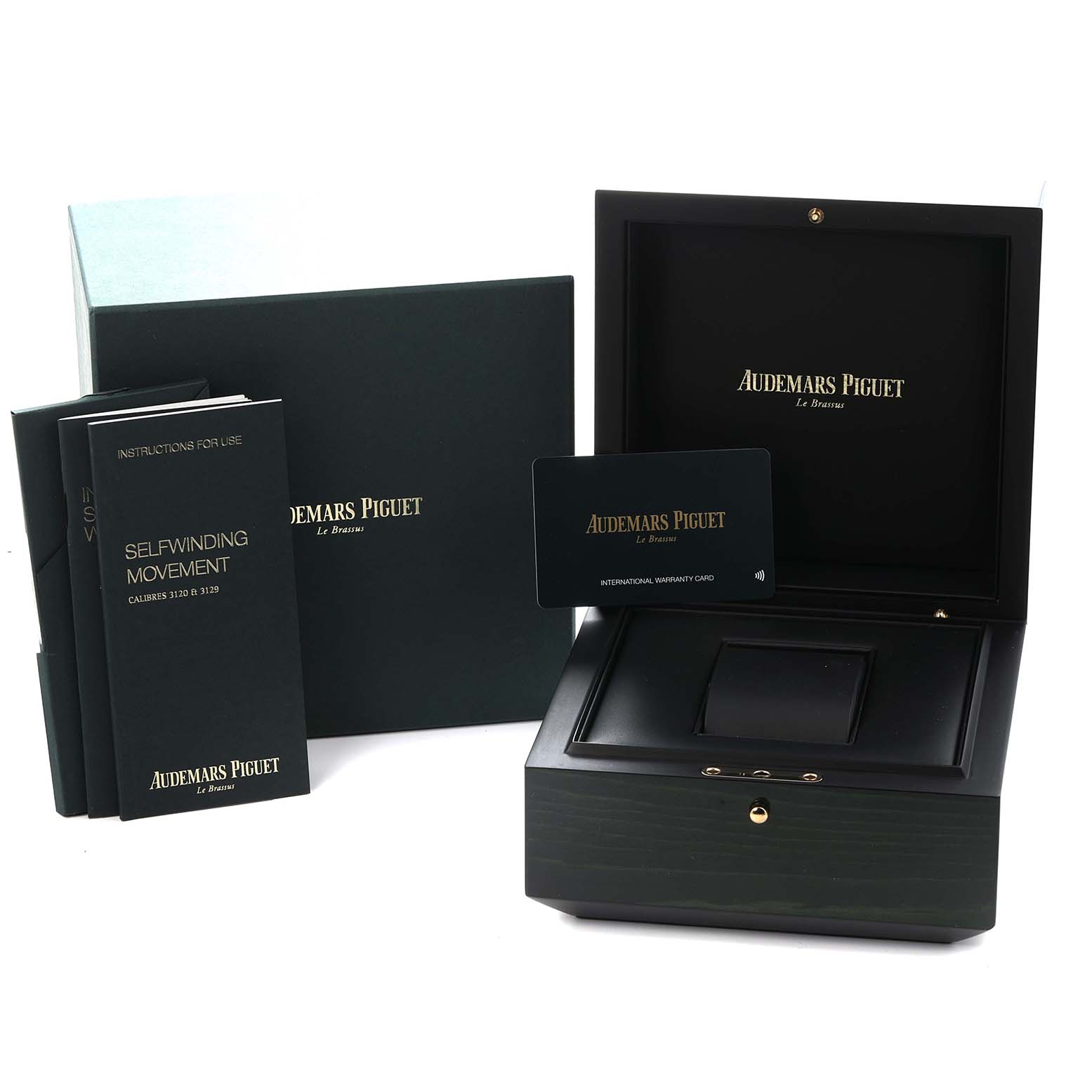 The image shows the packaging and accessories for an Audemars Piguet Royal Oak model 15451OR, including a presentation box and documentation.