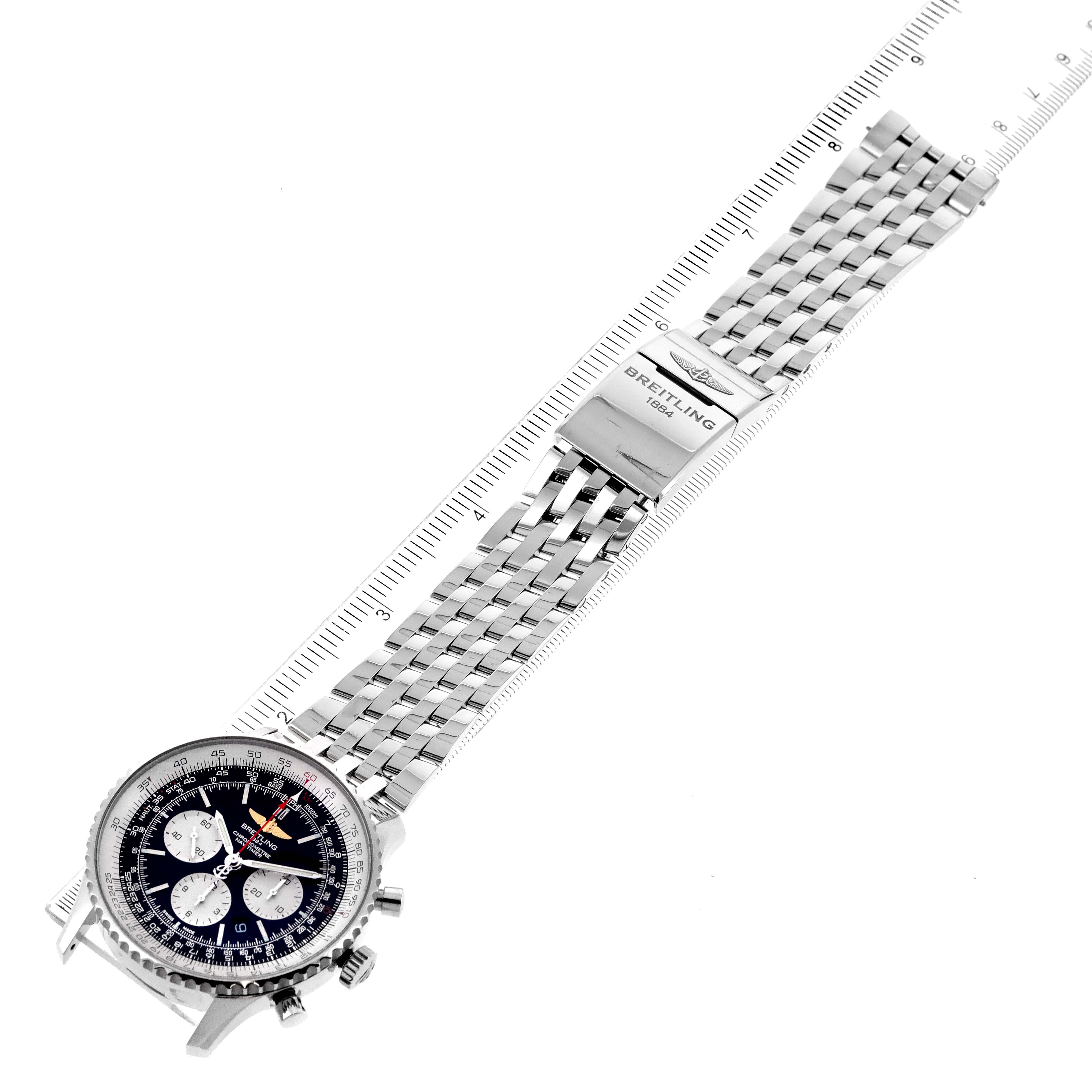 The image shows the Breitling Navitimer AB0127-211-B1A1 Men's Stainless Steel Black Dial AB0127-211-B1A1 Men's Stainless Steel Black Dial watch from an elevated angle, displaying the face, bezel, and full metal bracelet, along with a measuring scale for size reference.
