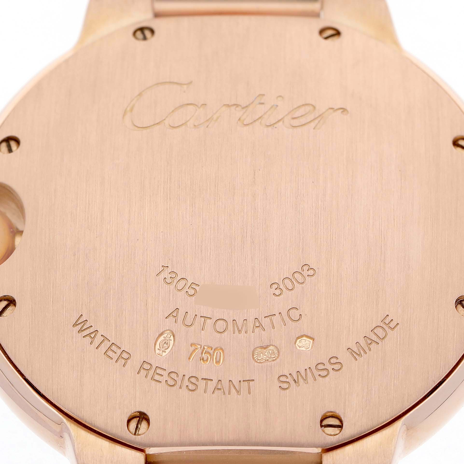 The image shows the back case of a Cartier Ballon Bleu WE9005Z3 Women's Rose Gold Silver Dial watch, featuring engravings and screws.
