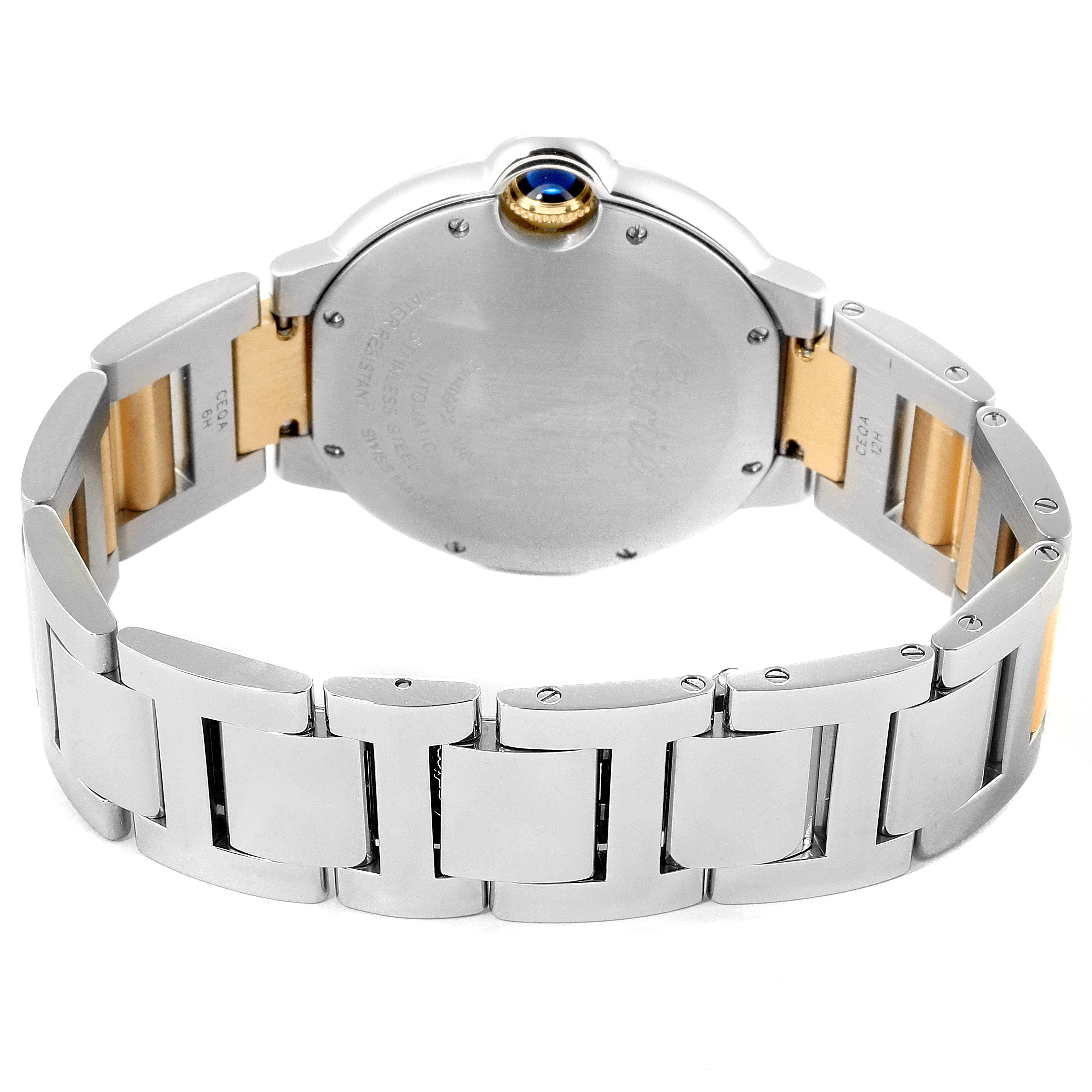 The image shows the back and bracelet of the Ballon Bleu model by Cartier, highlighting the metal links and crown with a blue cabochon.