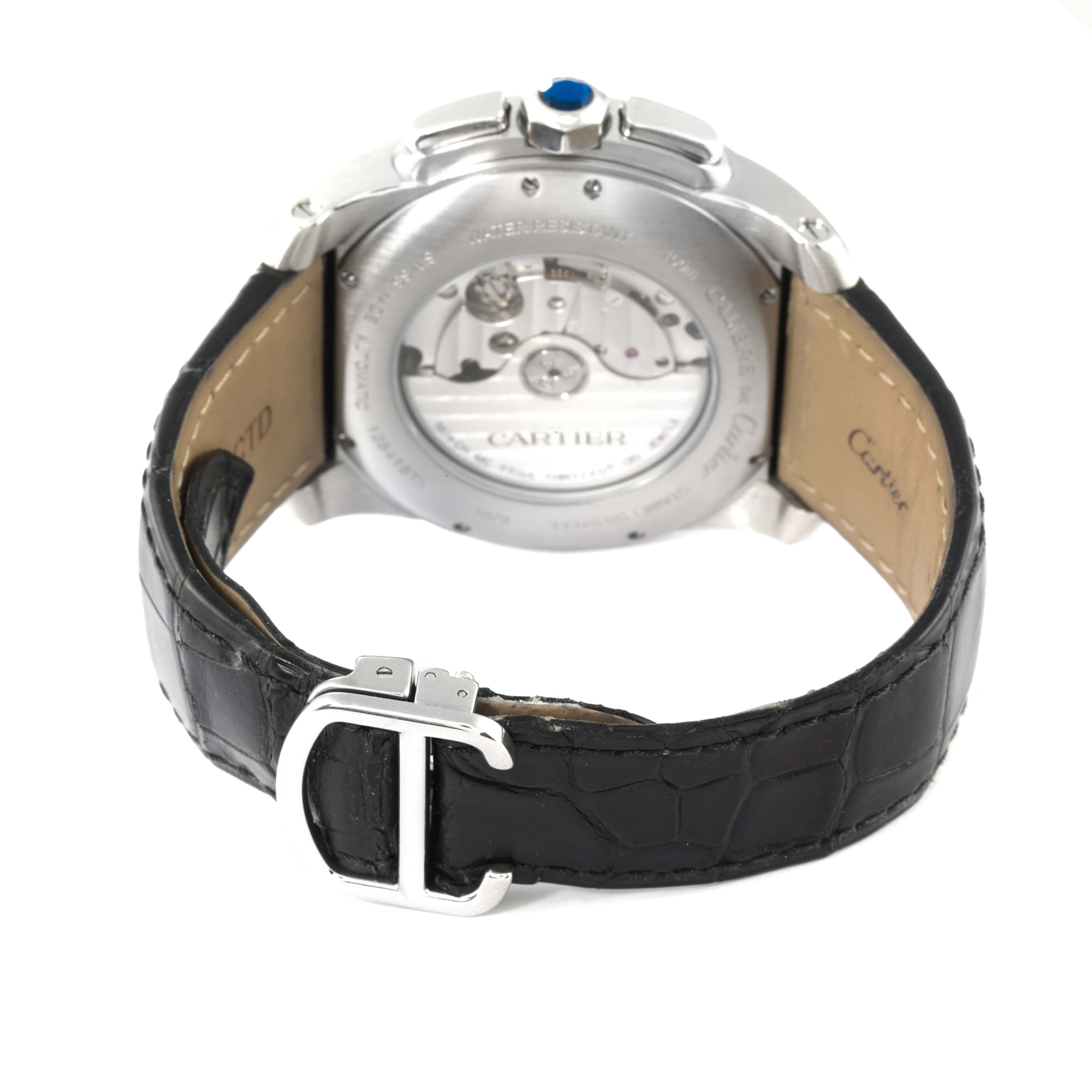 The image shows the back view of a Calibre de Cartier watch by Cartier, highlighting the watch's movement and black leather strap.