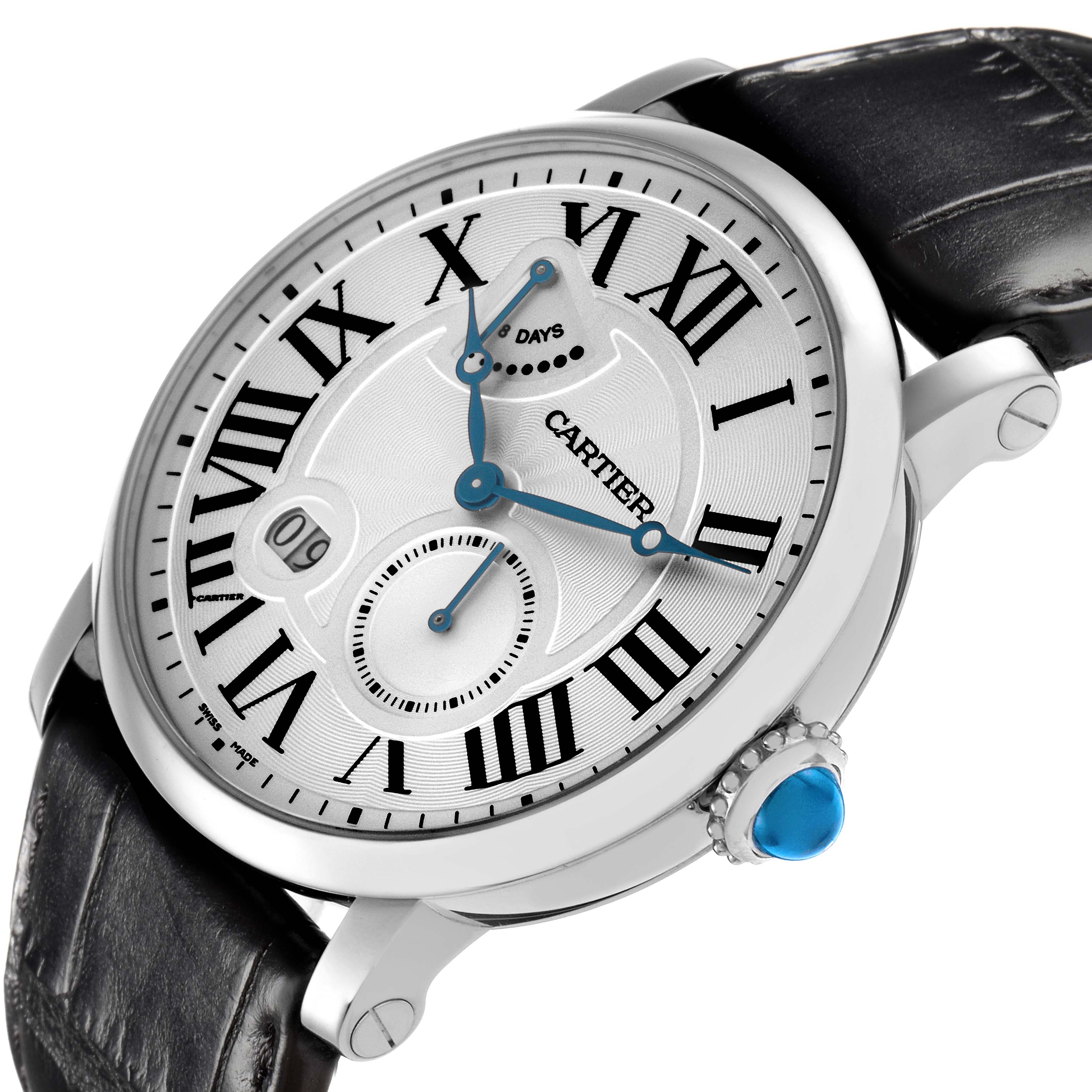 The Cartier Rotonde model W1556202 is shown at a slight angle, highlighting its dial, Roman numerals, blue hands, crown with a blue gemstone, and a black leather strap.