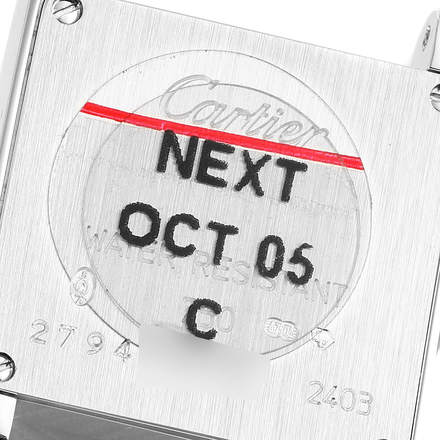 The image shows the back case of a Cartier Tank Francaise W5001256 Men's White Gold Silver Dial W5001256 Men's White Gold Silver Dial watch, displaying inscriptions and serial numbers.