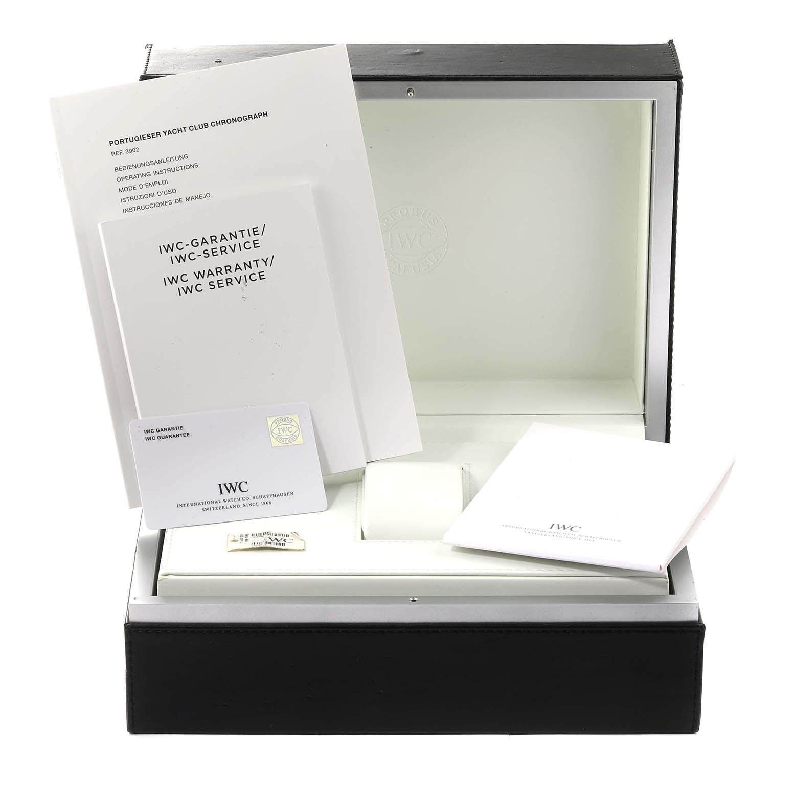 The image shows the packaging, warranty booklets, and cards for the IWC Portuguese IW390211 Men's Stainless Steel Silver Dial IW390211 Men's Stainless Steel Silver Dial model watch, viewed from the front.
