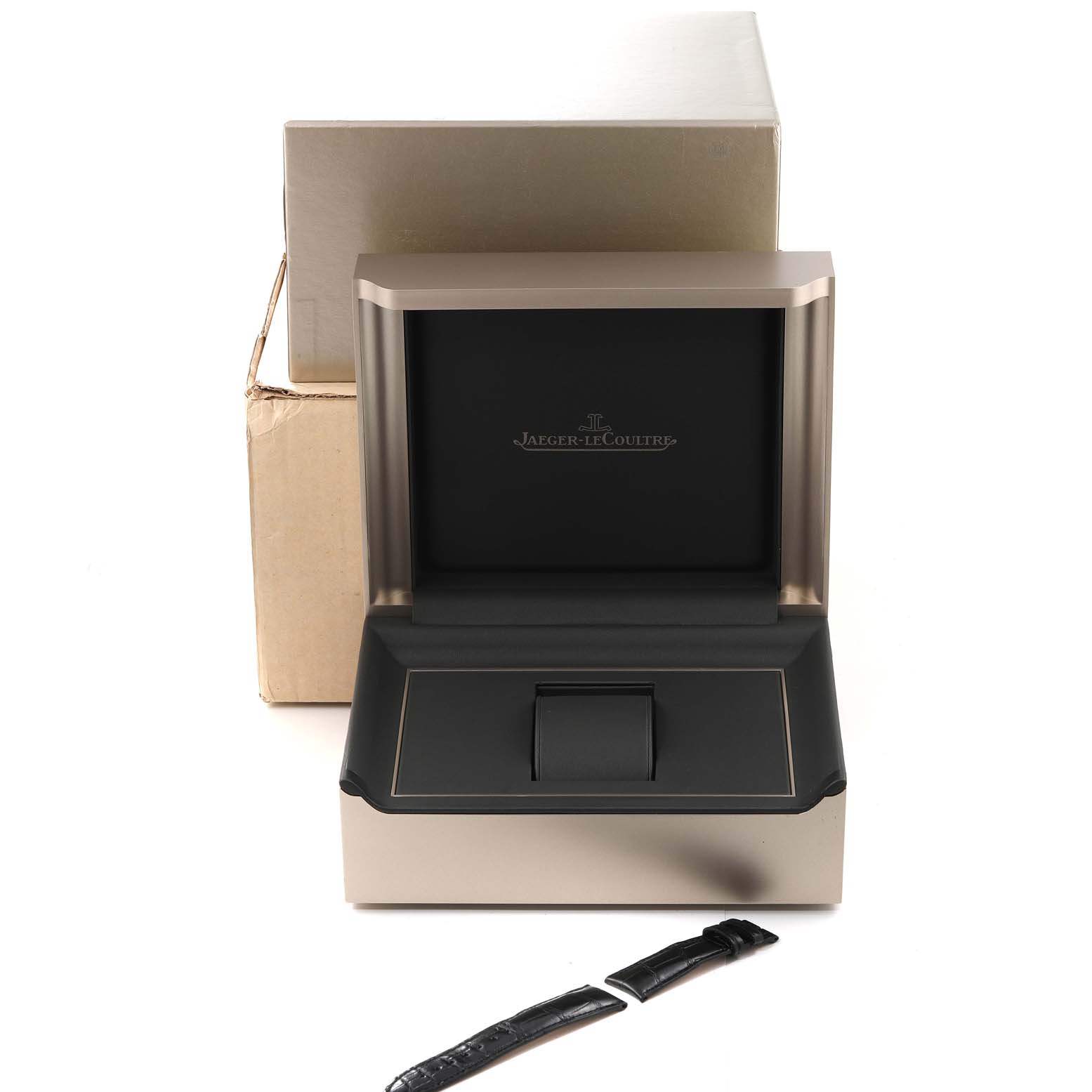 The image shows an open Jaeger LeCoultre Master Q1618420 Men's Stainless Steel Silver Dial Q1618420 Men's Stainless Steel Silver Dial watch box with an additional watch strap placed in front.