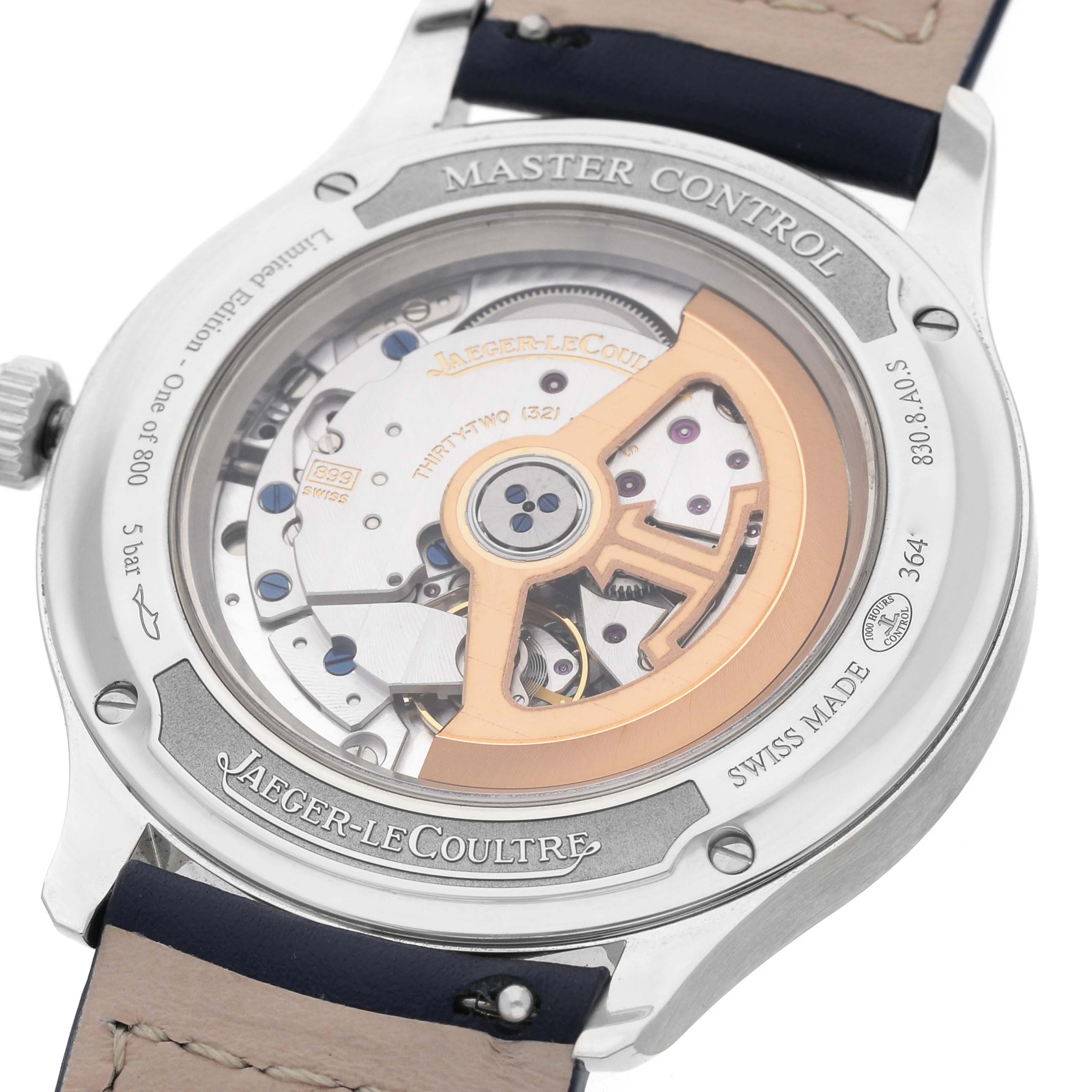 The image shows the back of a Jaeger LeCoultre Master Q4018480 Men's Stainless Steel Blue Dial Control watch, highlighting the movement and rotor.