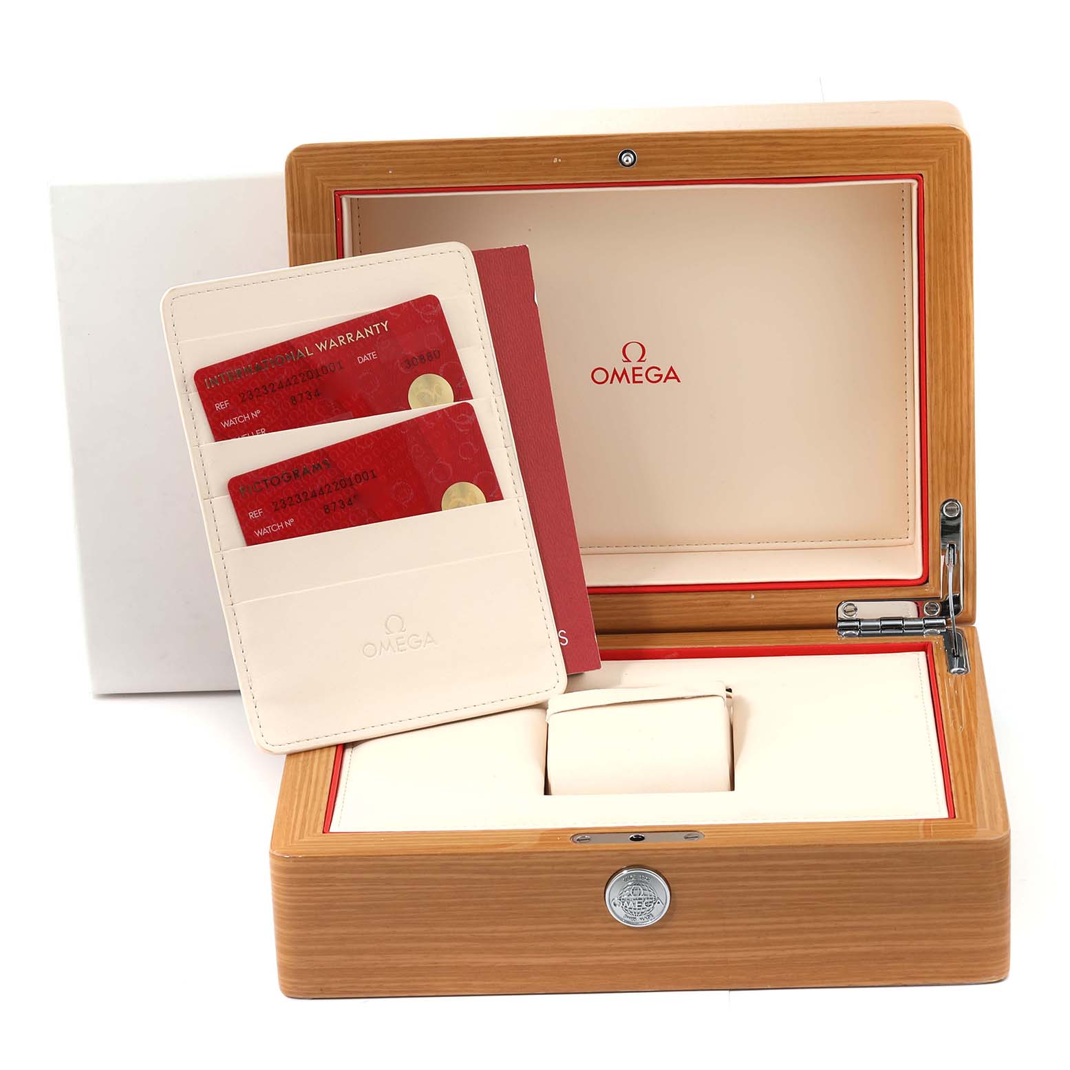 The image shows the wooden box, cushion, and warranty cards for the Omega Seamaster model watch.