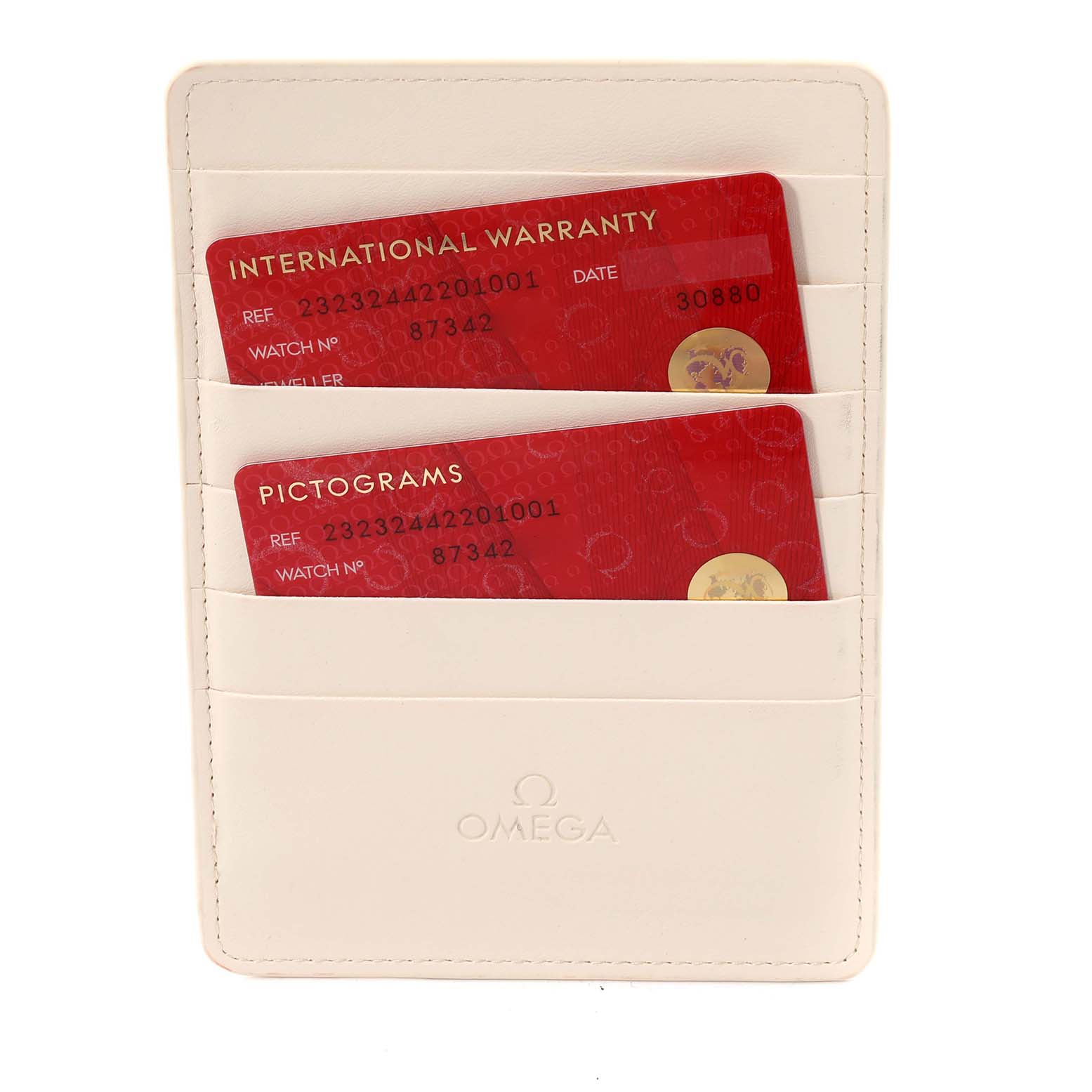 The image shows warranty and pictogram cards for an Omega Seamaster, displayed in a white cardholder.