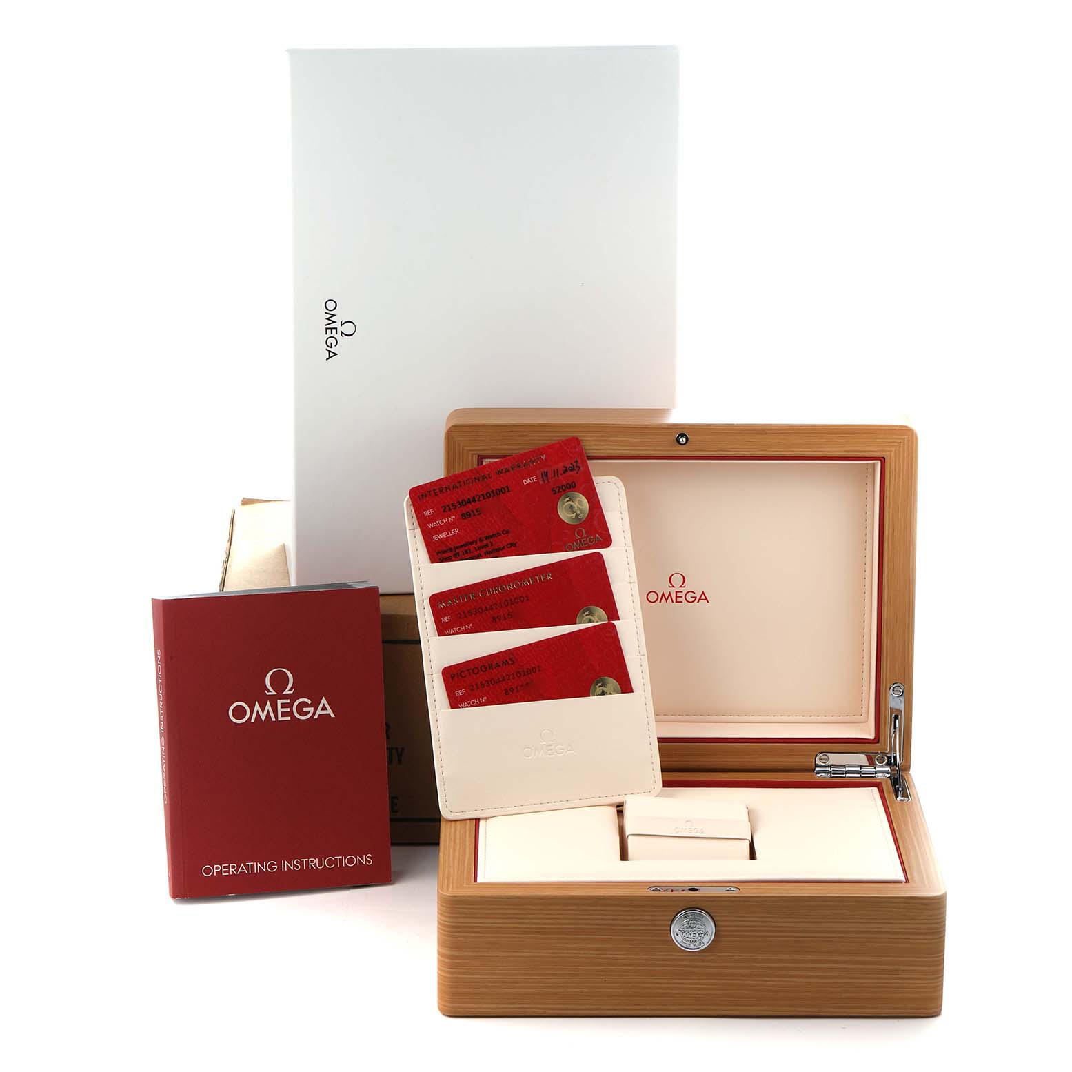 The image shows the packaging and accessories for the Omega Seamaster model 215.30.44.21.01.001, including a wooden box, warranty cards, and an instruction manual.