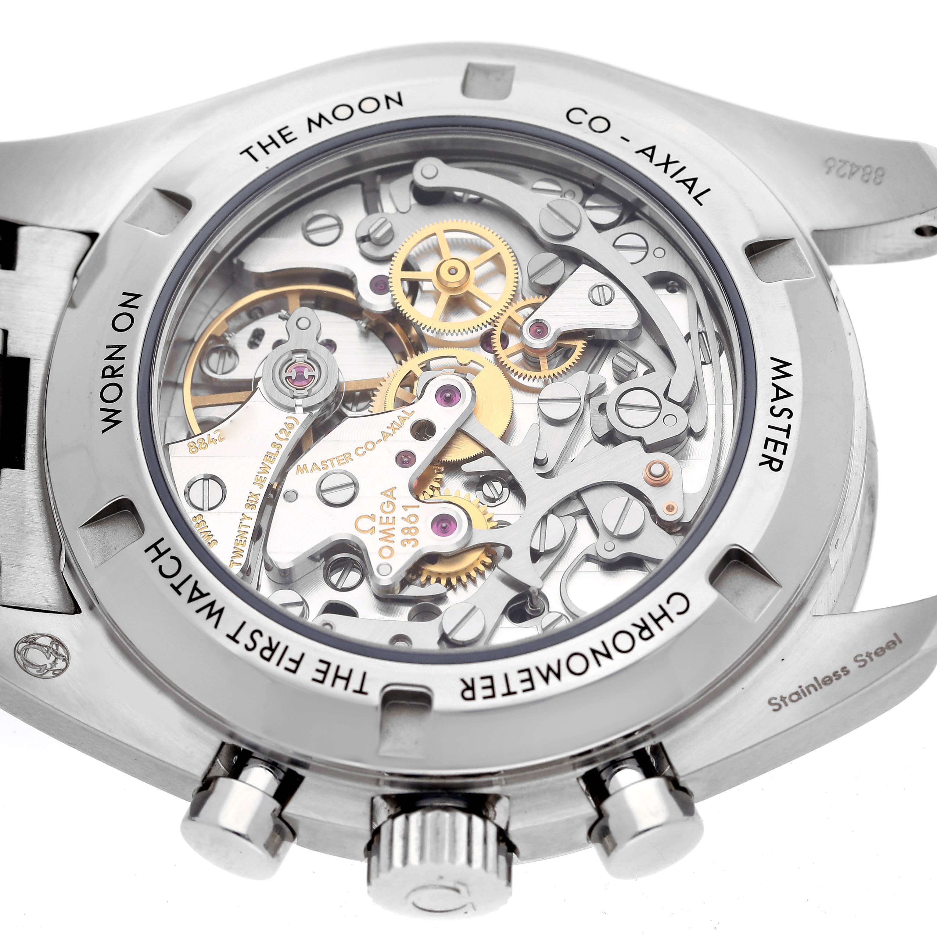 The image shows the back view of an Omega Speedmaster 310.30.42.50.04.001 Men
s Stainless Steel White Dial 310.30.42.50.04.001 Men
s Stainless Steel White Dial watch, highlighting its intricate mechanical movement and co-axial design.