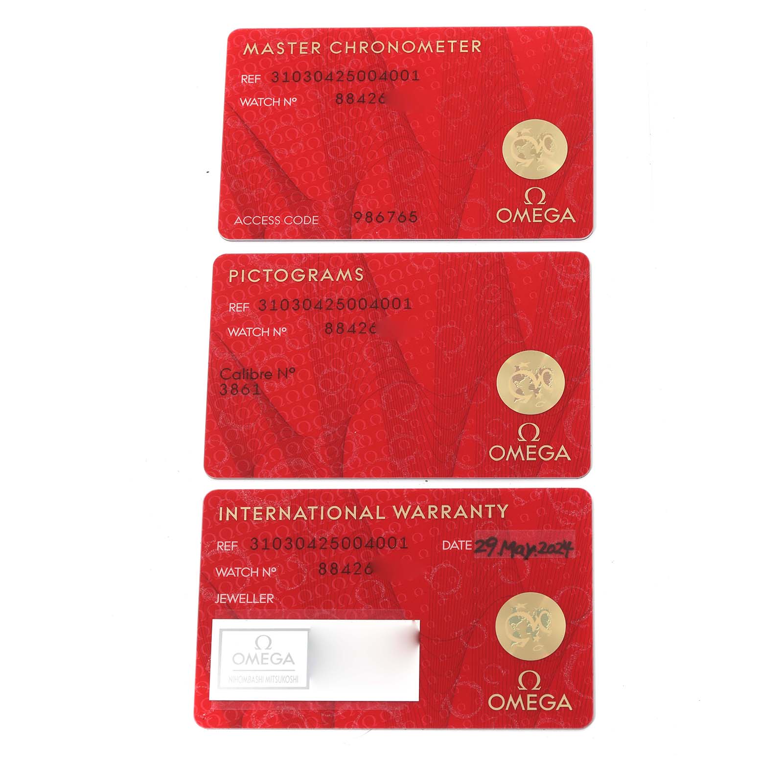 The image shows three red certification cards for an Omega Speedmaster 310.30.42.50.04.001 Men
s Stainless Steel White Dial 310.30.42.50.04.001 Men
s Stainless Steel White Dial watch, including Master Chronometer, Pictograms, and International Warranty.