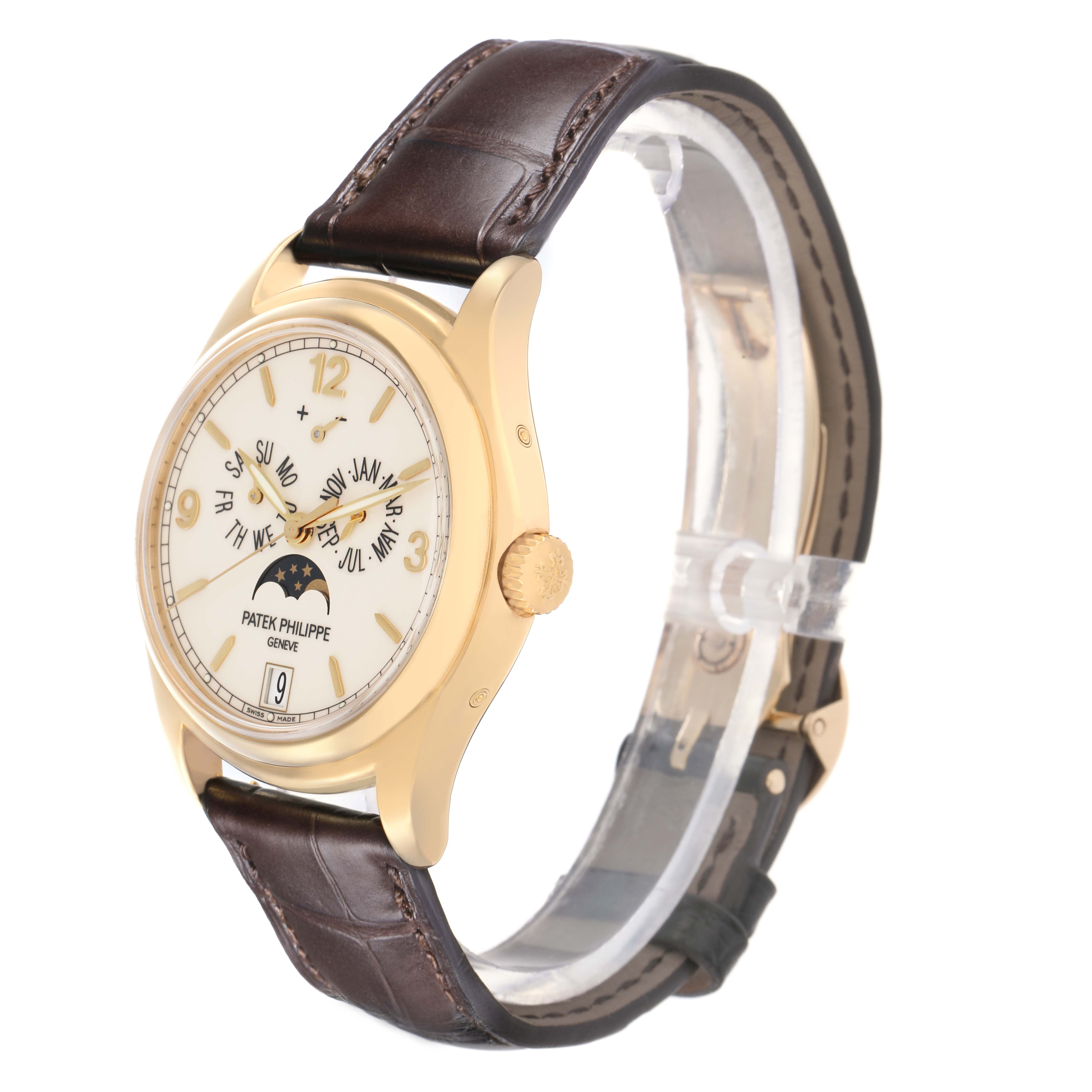 The Patek Philippe Complications 5146J Men
s watch is shown at an angled side view, highlighting its gold case, dial with complications, crown, and leather strap.