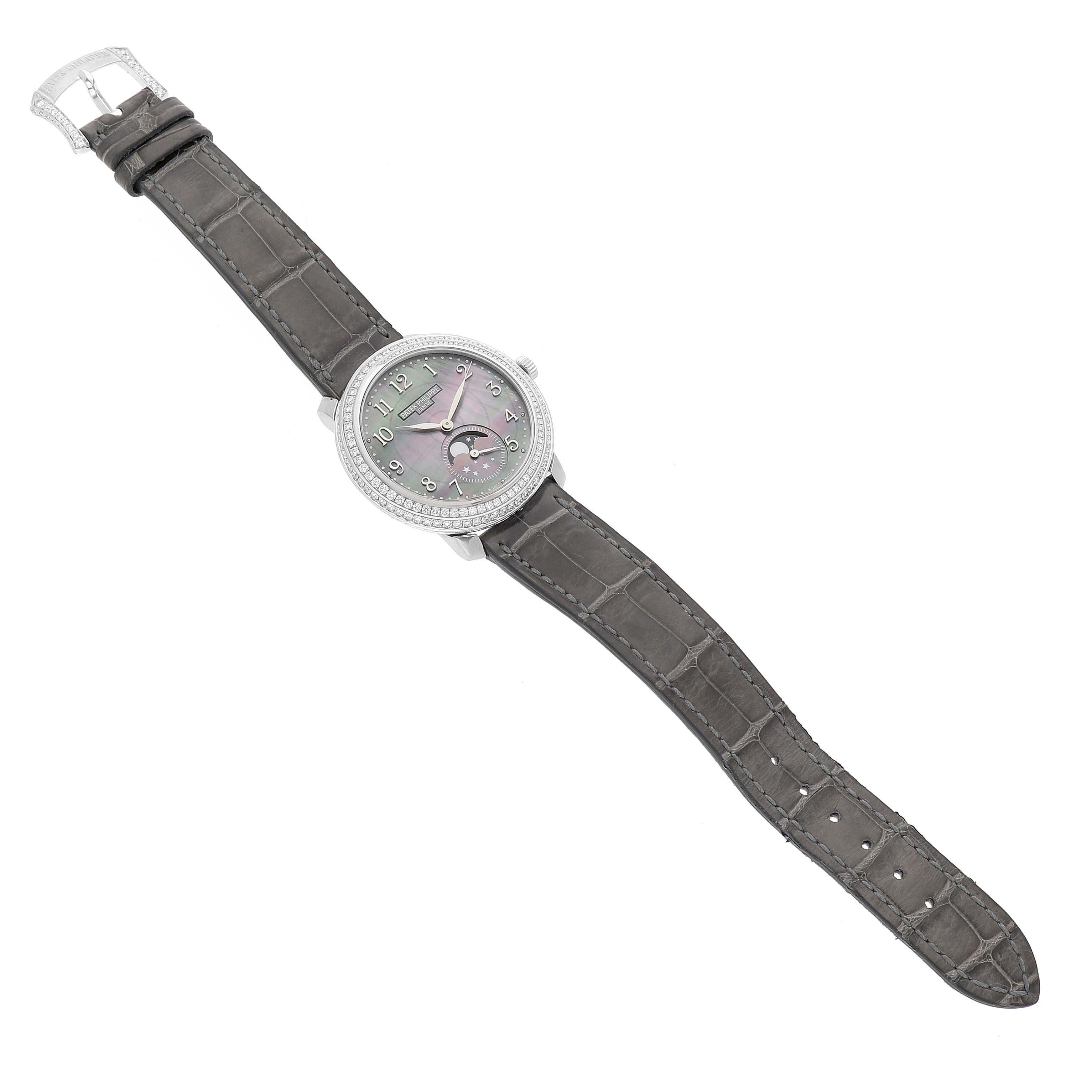 The Patek Philippe Complications 4968G Women's White Gold Mother of Pearl Dial watch is shown from a top-down angle, displaying its face, strap, and buckle.