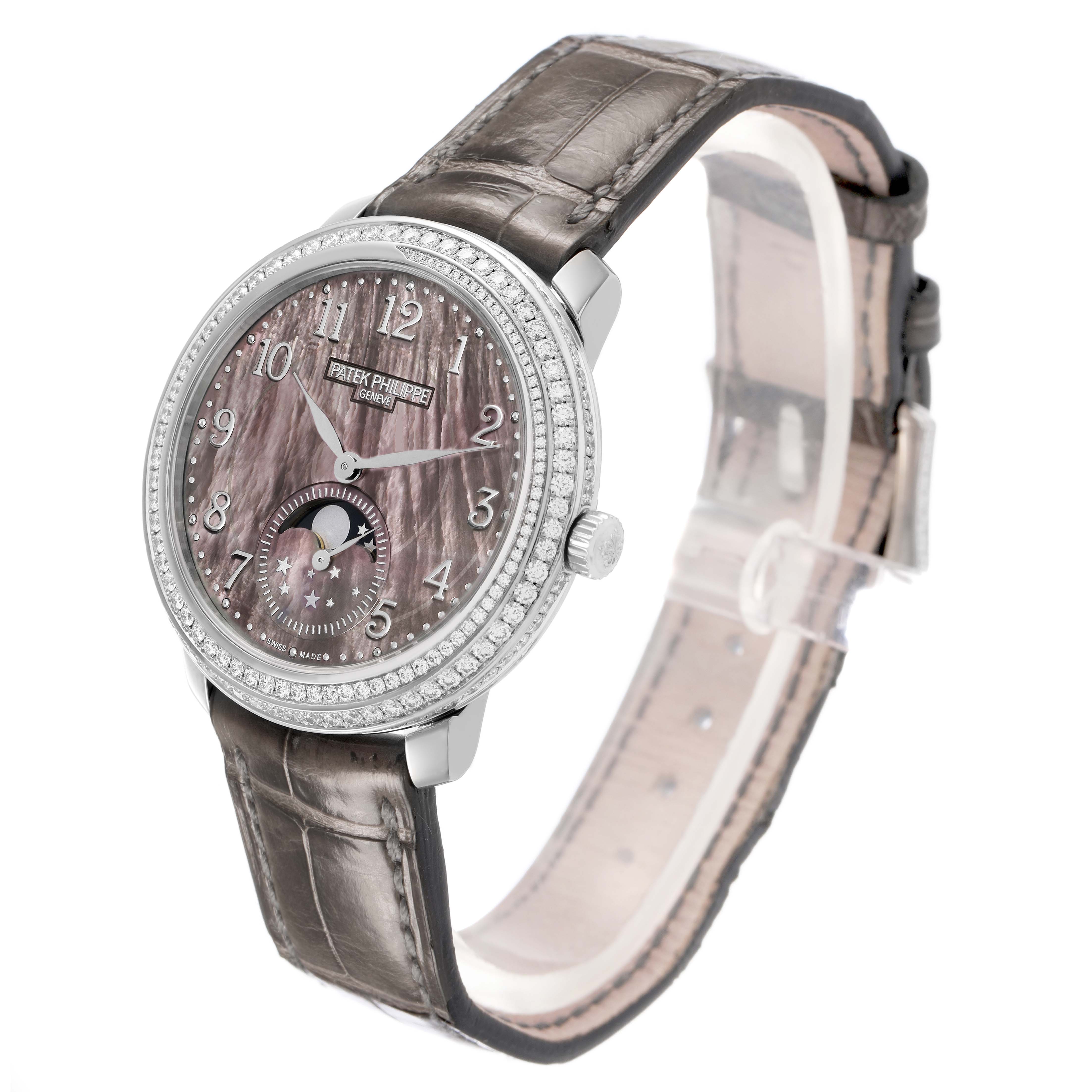 The Patek Philippe Complications 4968G Women's White Gold Mother of Pearl Dial watch is shown at a three-quarter angle, highlighting the face, dial, bezel, crown, and strap.