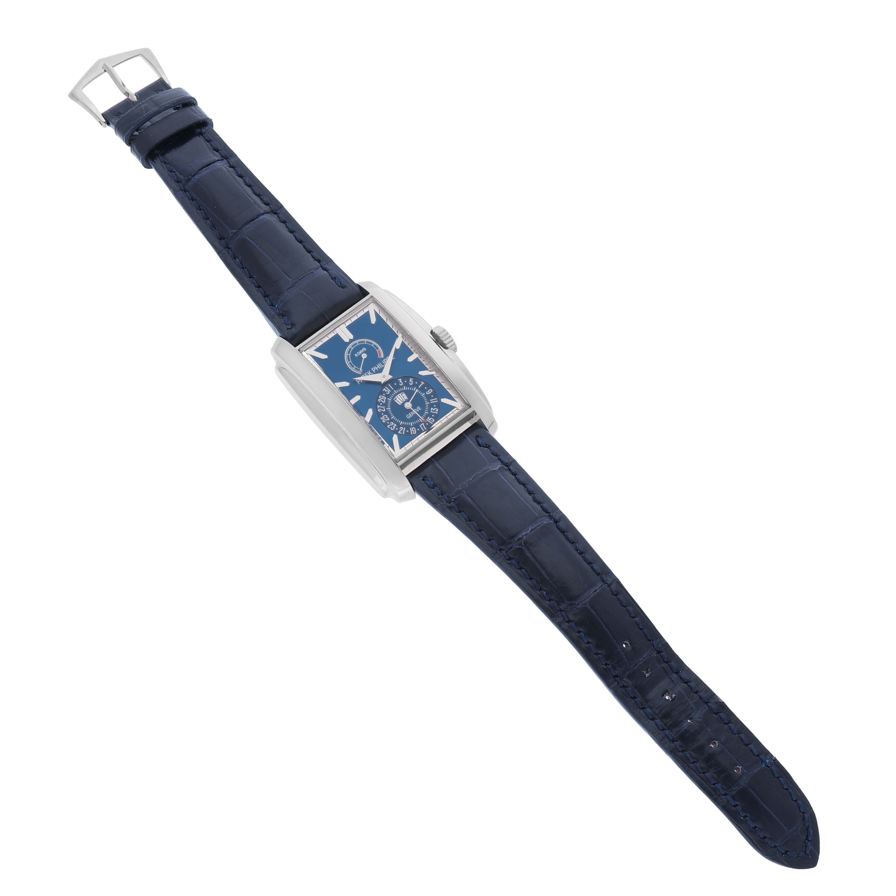 The Patek Philippe Gondolo 5200 Men's White Gold Blue Dial watch is shown at a slightly tilted angle, displaying the full strap and rectangular dial.