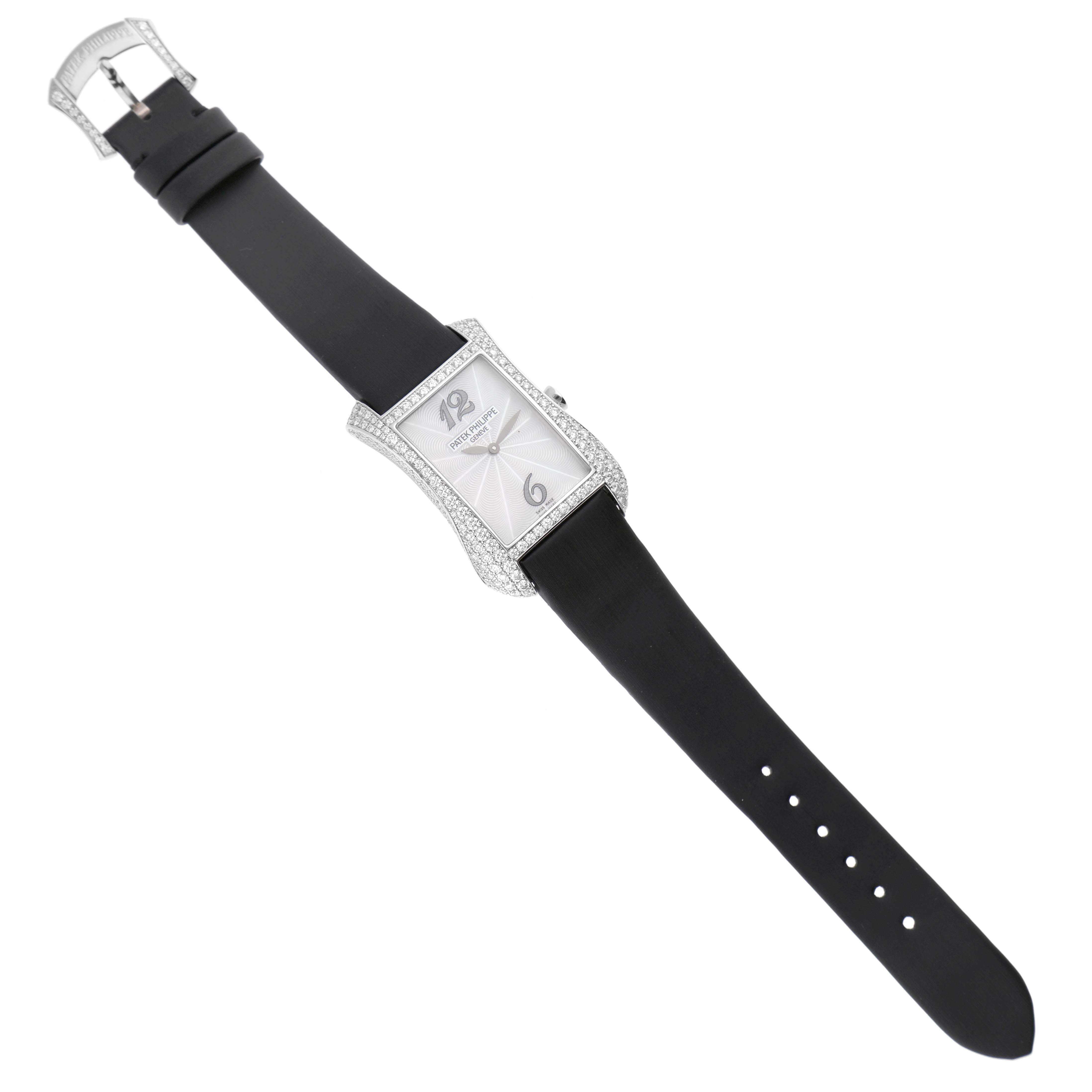 The Patek Philippe Gondolo 4973G Women's White Gold Mother of Pearl Dial watch is shown from a top-down angle, displaying the face, case, strap, and buckle.