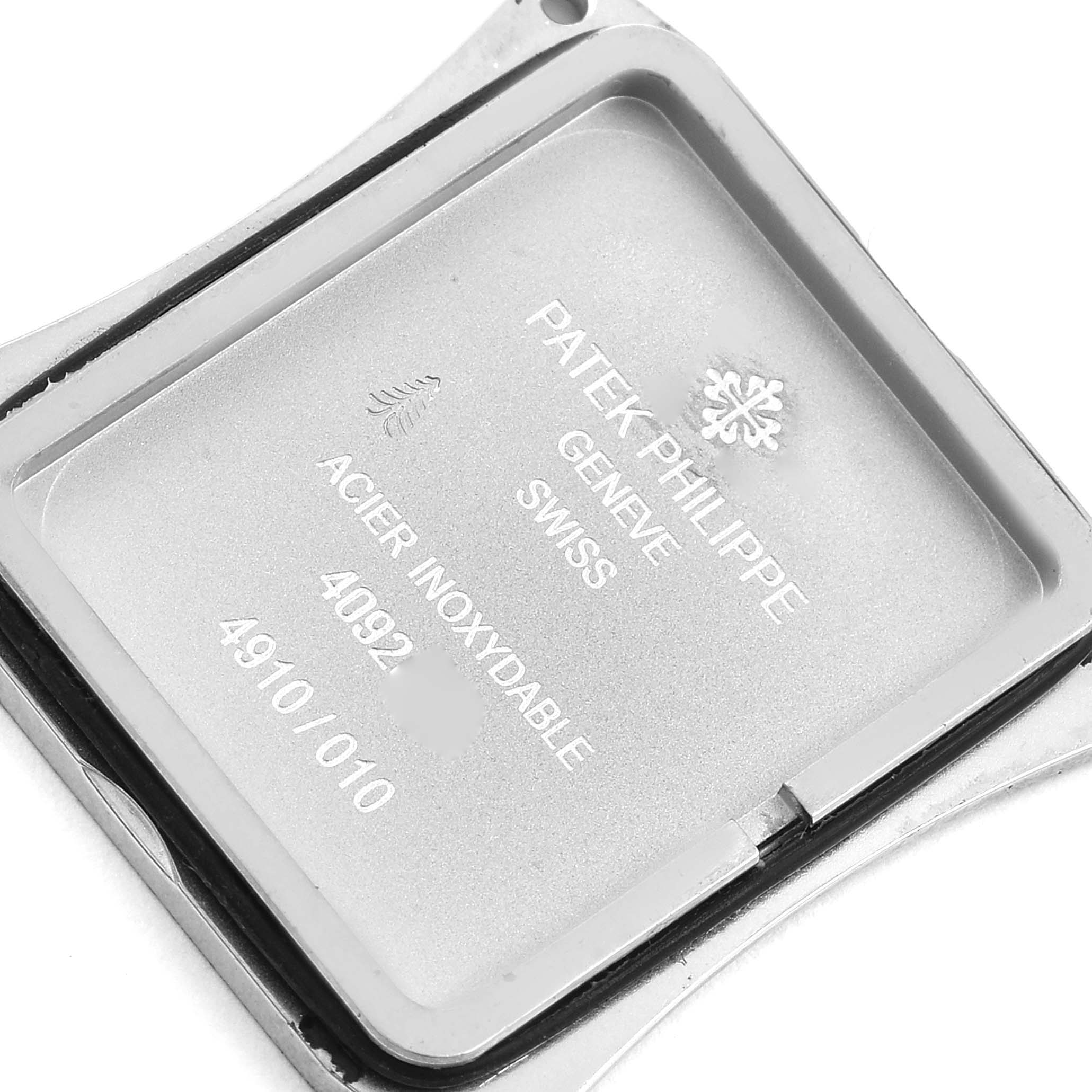 The image shows the back case of a Patek Philippe Twenty-4 4910/10A-010 Women's Stainless Steel Silver Dial 4910/10A-010 Women's Stainless Steel Silver Dial watch, highlighting the brand engravings and model details.