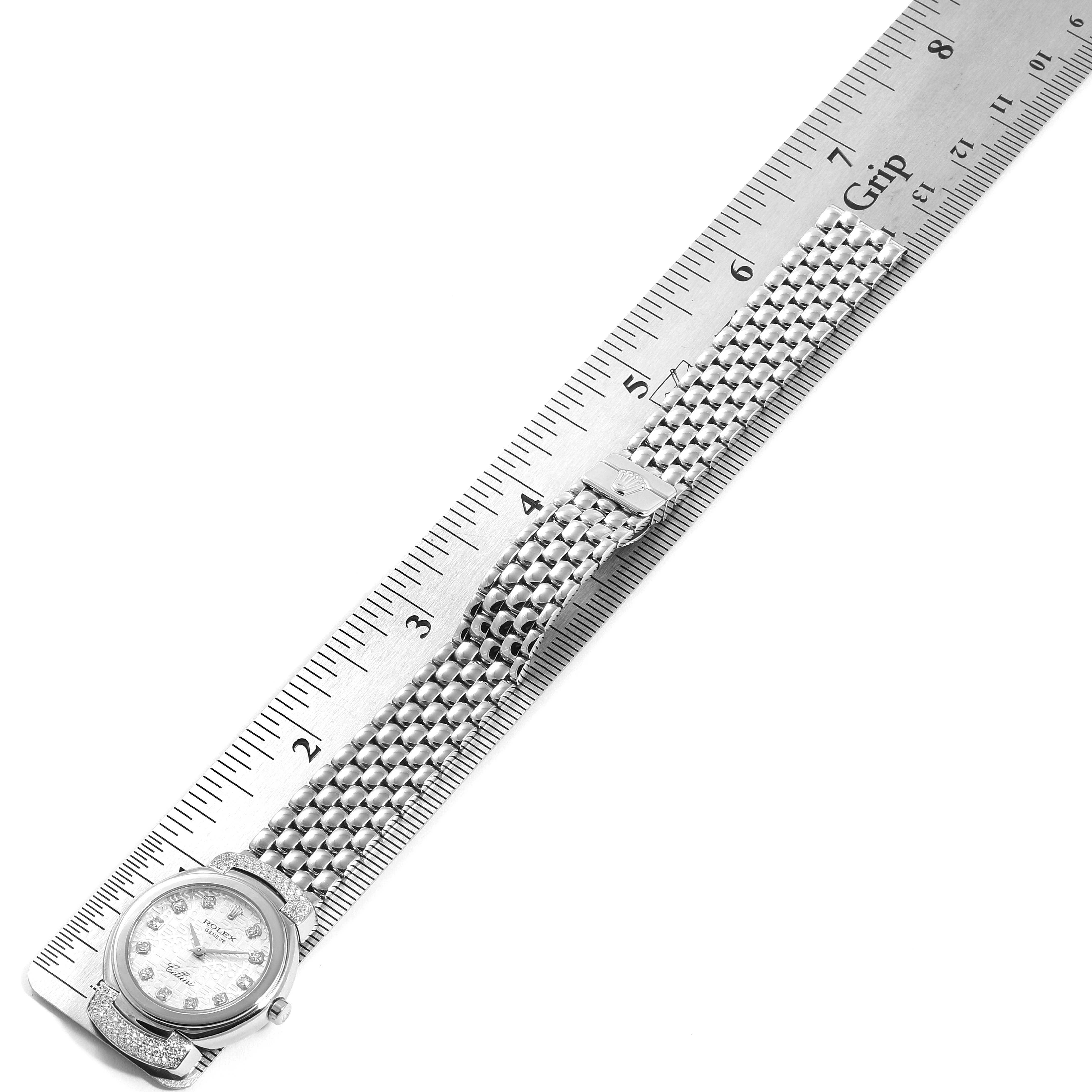 The image showcases a Rolex Cellini 6672 Women's White Gold Silver Dial 6672 Women's White Gold Silver Dial watch from a top-down angle alongside a ruler for measurement, highlighting the face and bracelet.