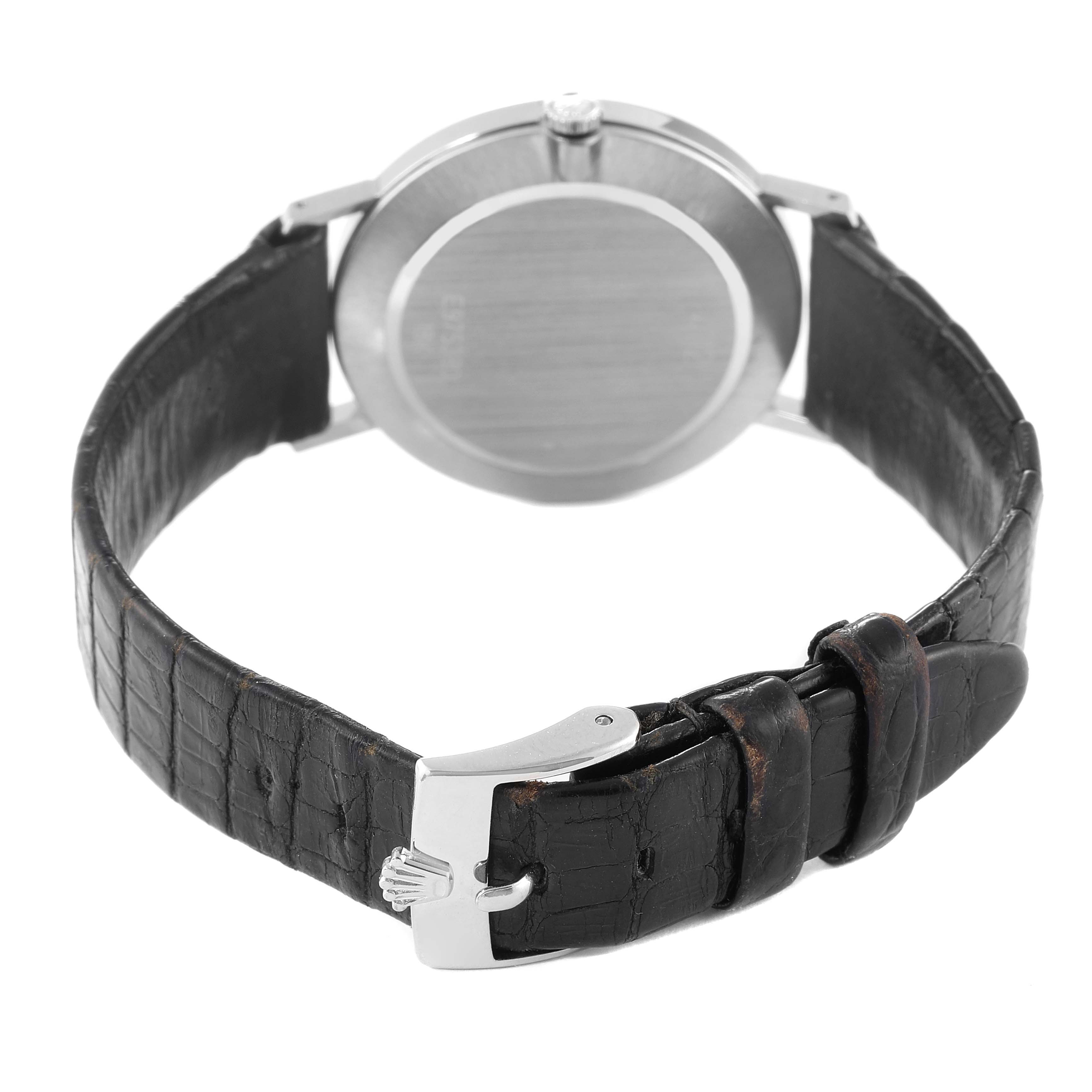 The image shows the back of a Rolex Cellini 4112 Men
s White Gold Silver Dial 4112 Men
s White Gold Silver Dial watch, including its case back, crown, and leather strap with the clasp.