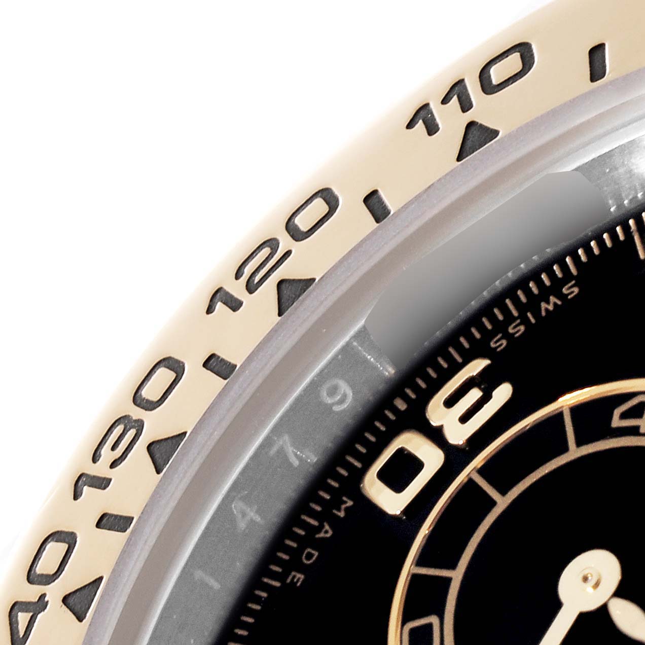 This image shows a close-up of the bezel and part of the dial of a Rolex Daytona 116503 Men
s Steel and Gold (two tone) Black Dial 116503 Men
s Steel and Gold (two tone) Black Dial watch.
