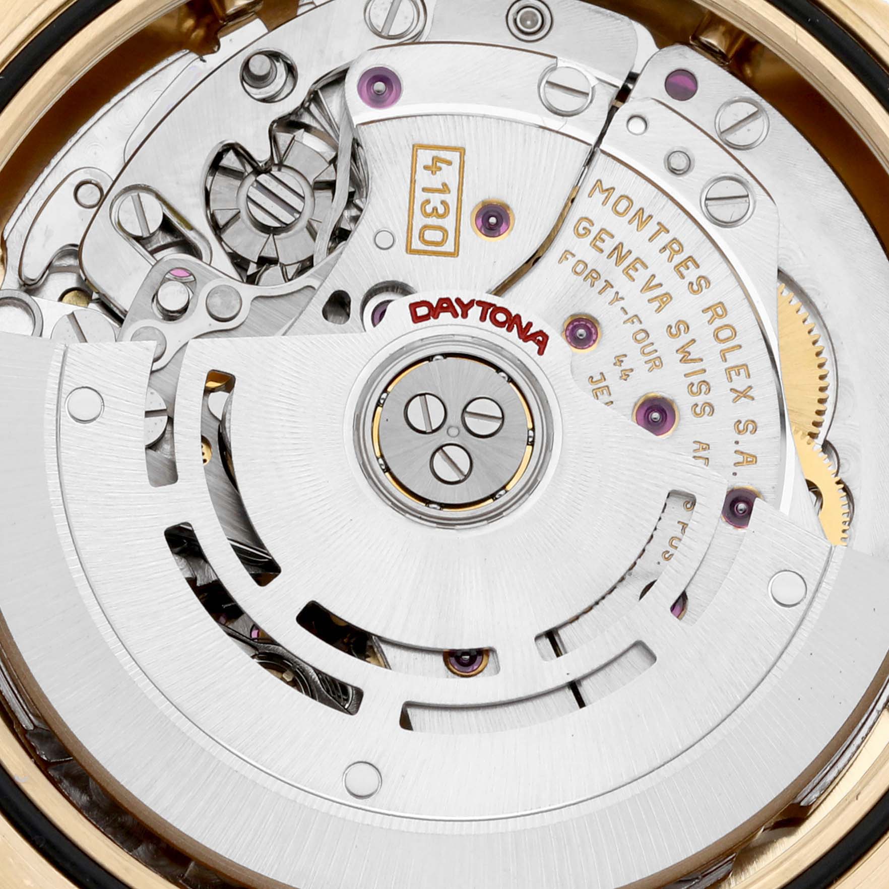 This close-up image shows the intricate internal mechanism of the Rolex Daytona 116528 Men
s Yellow Gold Black Dial 116528 Men
s Yellow Gold Black Dial watch, highlighting the movement parts and engravings.
