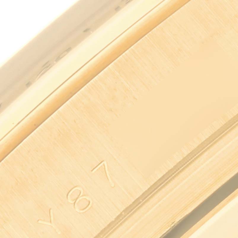 This close-up image shows the edge and engraved part of the bezel on a Rolex Daytona 116528 Men
s Yellow Gold Black Dial 116528 Men
s Yellow Gold Black Dial watch.