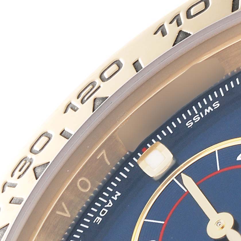 This image shows a close-up of the dial and bezel of a Rolex Daytona 116528 Men's Yellow Gold Blue Dial 116528 Men's Yellow Gold Blue Dial watch.
