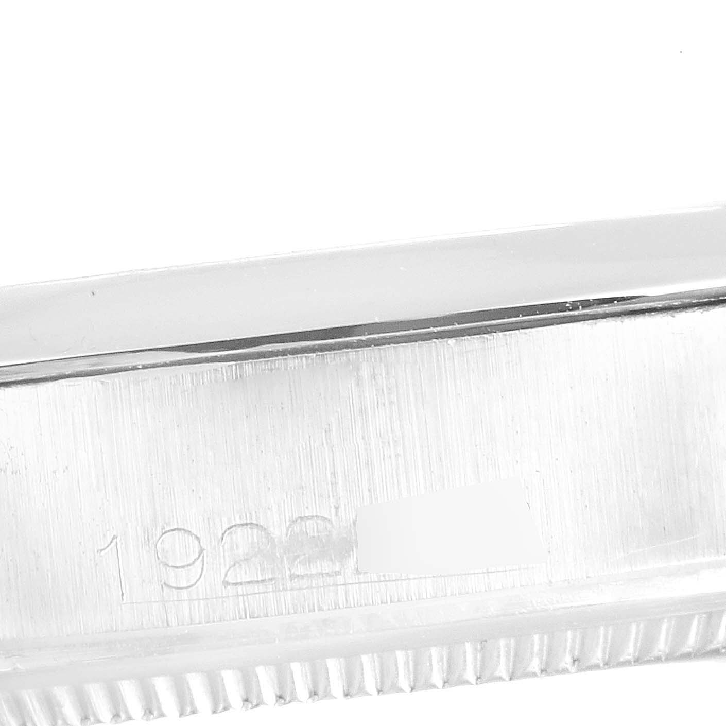 The image shows a close-up of the side of a Rolex Vintage Collection 1500 Men's Stainless Steel Black Dial 1500 Men's Stainless Steel Black Dial watch, focusing on the serial number and edge of the bezel.