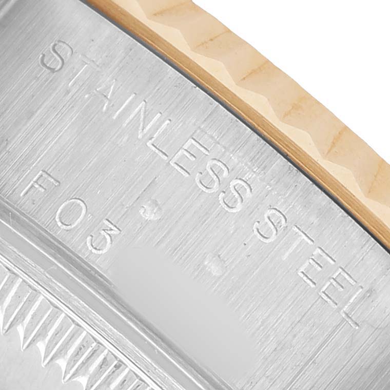 The image shows a close-up of the inscription on the case side of a Rolex Datejust 79173 Women's Stainless Steel White Dial, highlighting "STAINLESS STEEL".