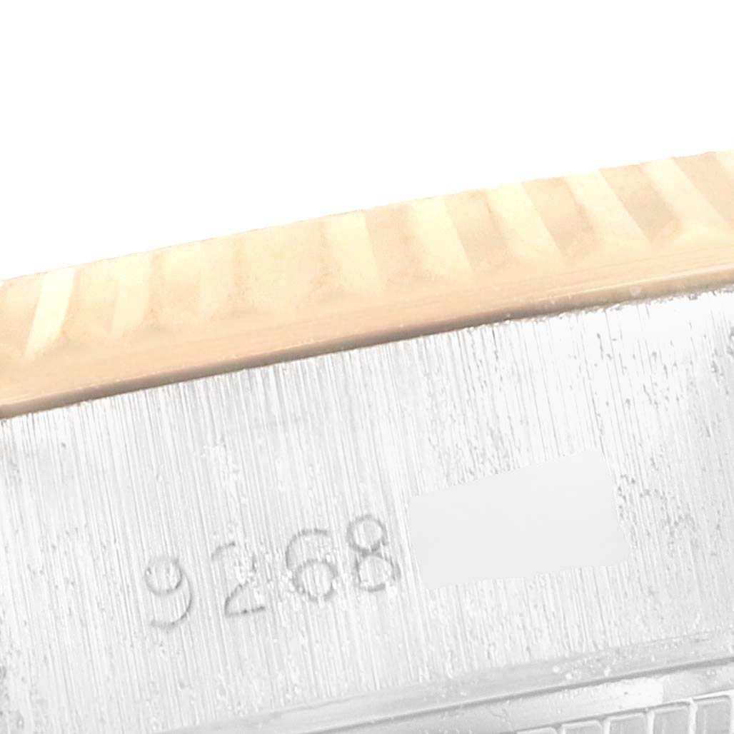 This close-up image shows the engraved serial number area and part of the fluted bezel of a Rolex Datejust 69173 Women's Steel and Gold (two tone) Champagne Dial 69173 Women's Steel and Gold (two tone) Champagne Dial watch.