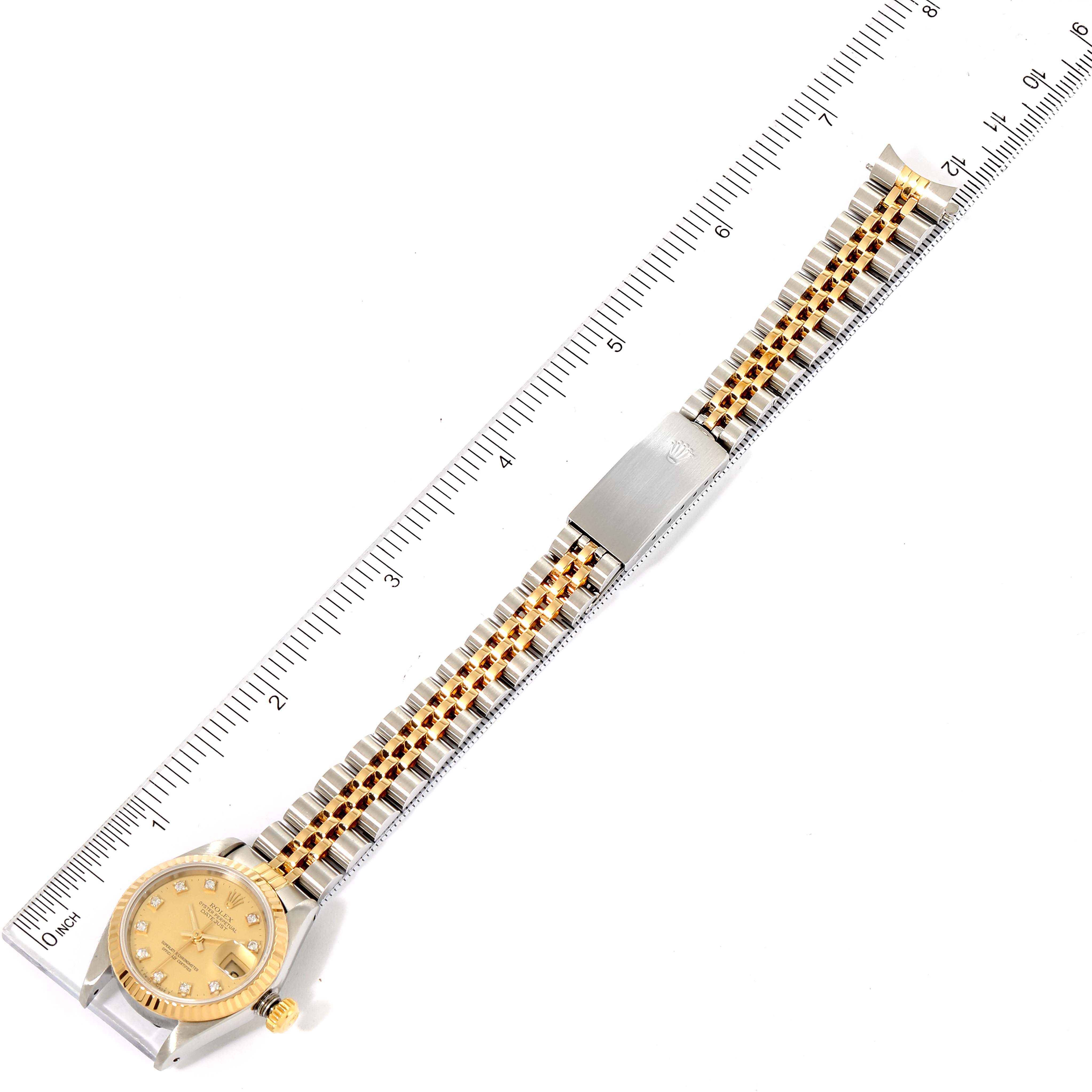 The image shows a Rolex Datejust 69173 Women's Steel and Gold (two tone) Champagne Dial 69173 Women's Steel and Gold (two tone) Champagne Dial watch laid flat with a ruler for measurement, highlighting the face, band, and clasp.