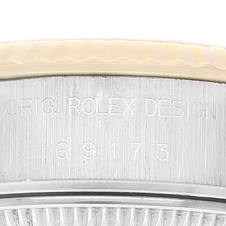 This image shows a close-up of the model number and "ORIG. ROLEX DESIGN" engraving on the side of a Rolex Datejust 69173 Women's Steel and Gold (two tone) Champagne Dial 69173 Women's Steel and Gold (two tone) Champagne Dial watch case.