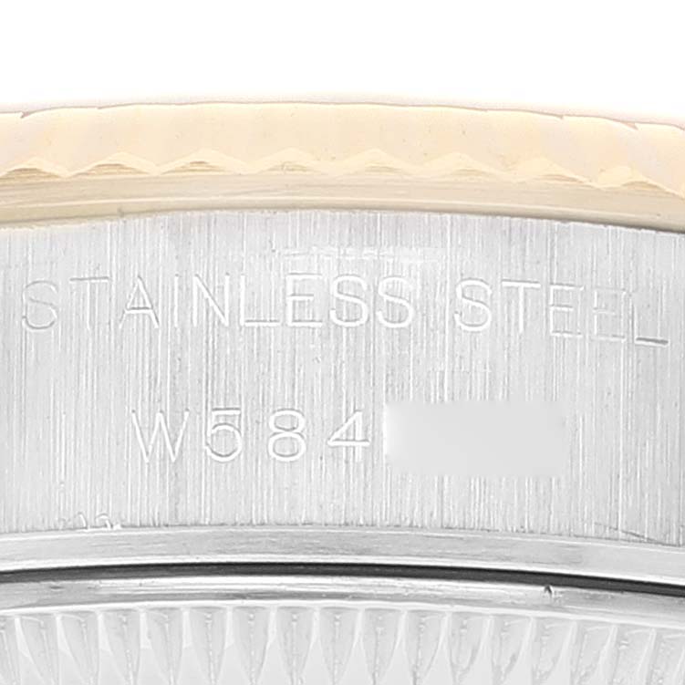 This image shows a close-up of the stainless steel case back and part of the bezel of a Rolex Datejust 69173 Women's Steel and Gold (two tone) Champagne Dial 69173 Women's Steel and Gold (two tone) Champagne Dial watch.
