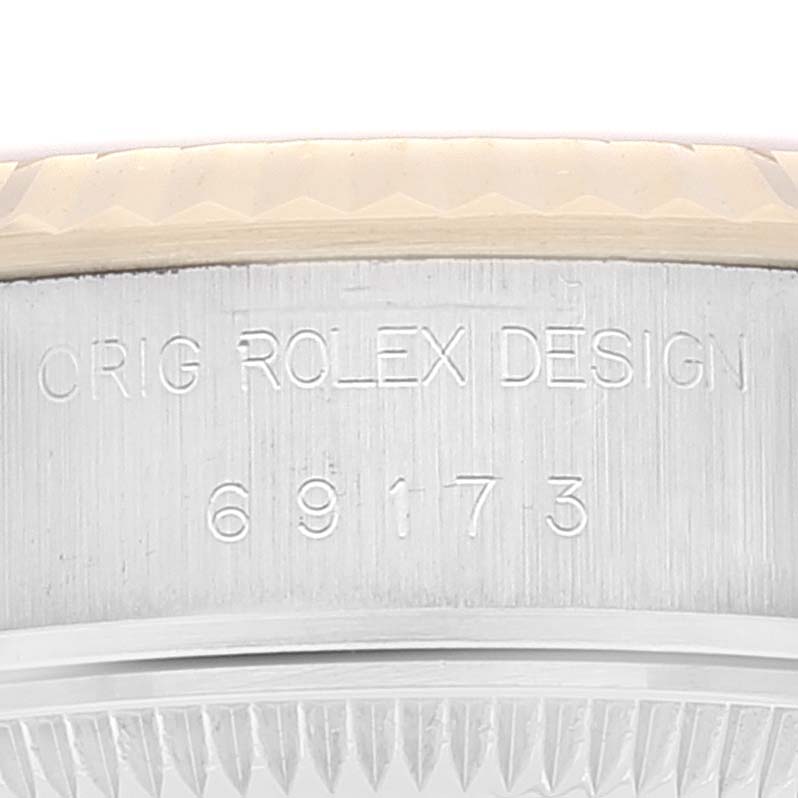 This image shows a close-up of the serial number engraving on the case side of a Rolex Datejust 69173 Women's Steel and Gold (two tone) Champagne Dial 69173 Women's Steel and Gold (two tone) Champagne Dial model.