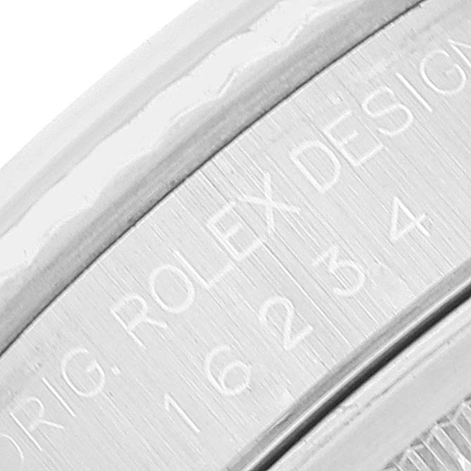 The image shows an engraved close-up of the case side of a Rolex Datejust 16234 Men's Stainless Steel White Dial 16234 Men's Stainless Steel White Dial watch, highlighting the model number.