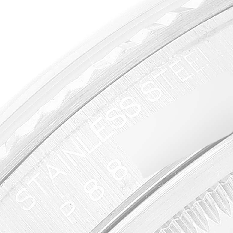 This image displays a close-up of a section of the stainless steel bezel on a Rolex Datejust 16234 Men's Stainless Steel White Dial 16234 Men's Stainless Steel White Dial watch.